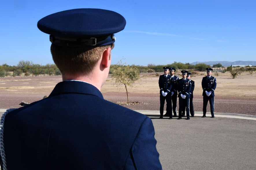a phot of DM Base Honor Guard details standing at-ease