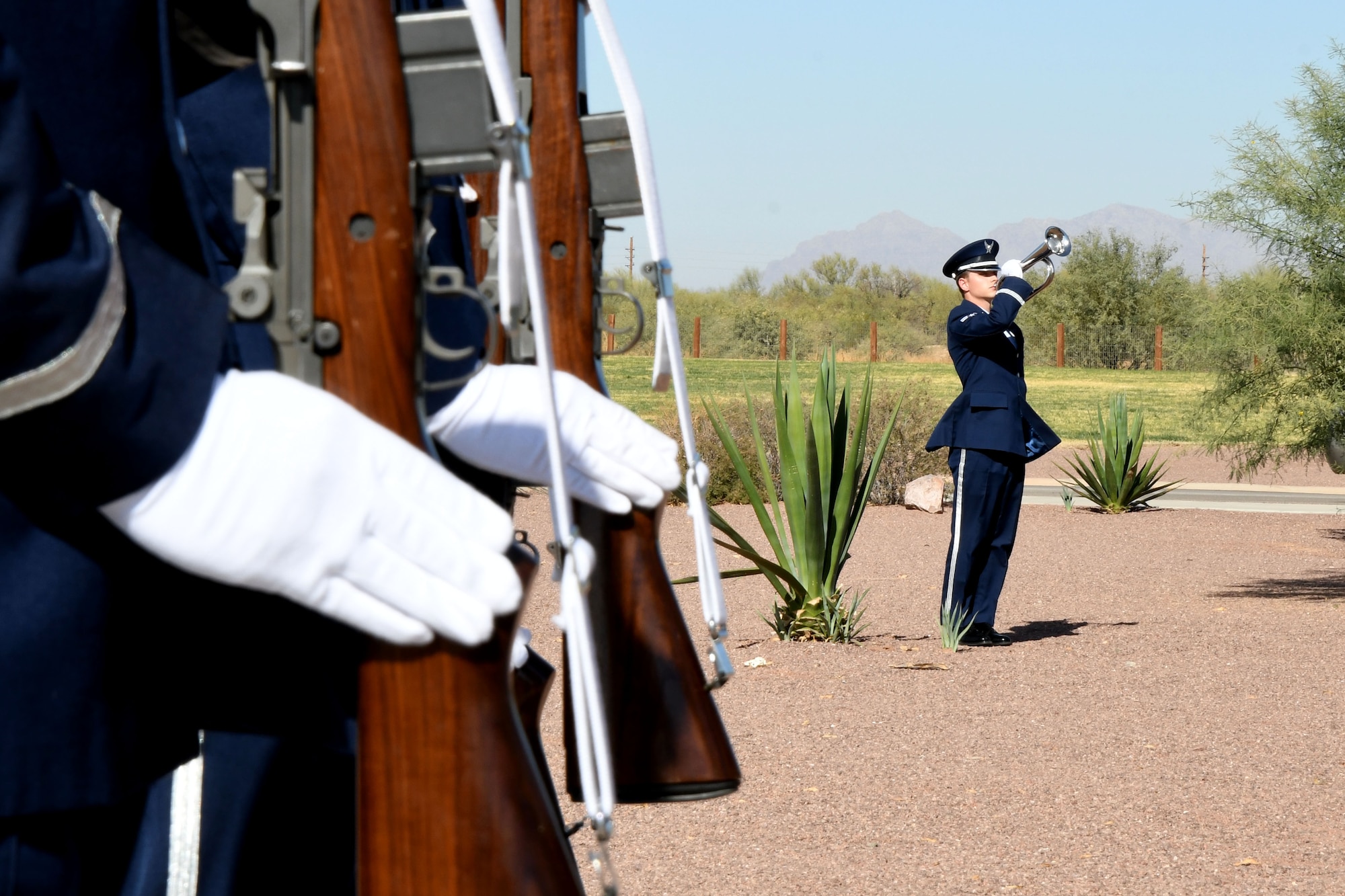 a photo of DM Base Honor Guardsman playing taps