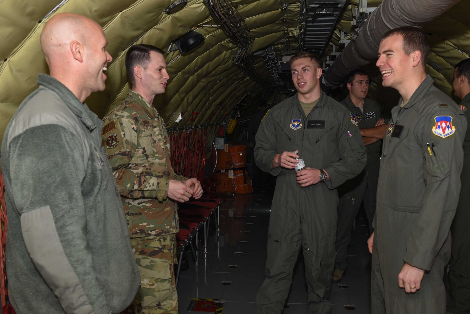 Staff Sgt. Padriac Condon, 344th Air Refueling Squadron boom operator, and Staff Sgt. Nicholes Mahon, 22 Aircraft Maintenance Squadron crew chief, speak with 2nd Lt. Tristyn Hanson and Blake Lawrie, 71st Operations Support Squadron officers awaiting pilot training, on the importance of the pilots and maintainers relationship during the Air Education and Training Command Fly-In Nov. 15, 2019, at McConnell Air Force Base, Kan. Students were able to speak with air crews while touring the KC-46 Pegasus and KC-135 Stratotanker. (U.S. Air Force photo by Airman 1st Class Alexi Bosarge)