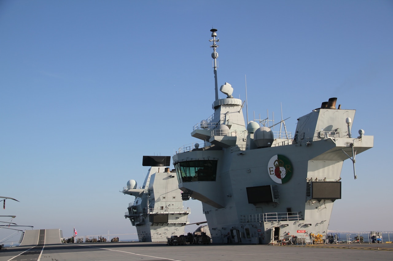 Two “islands” tower over an aircraft carrier’s flight deck.