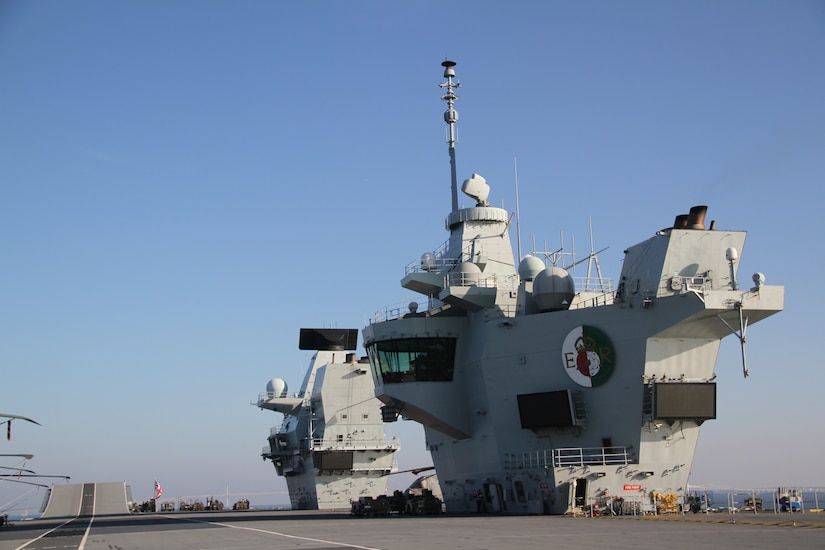 Two “islands” tower over an aircraft carrier’s flight deck.