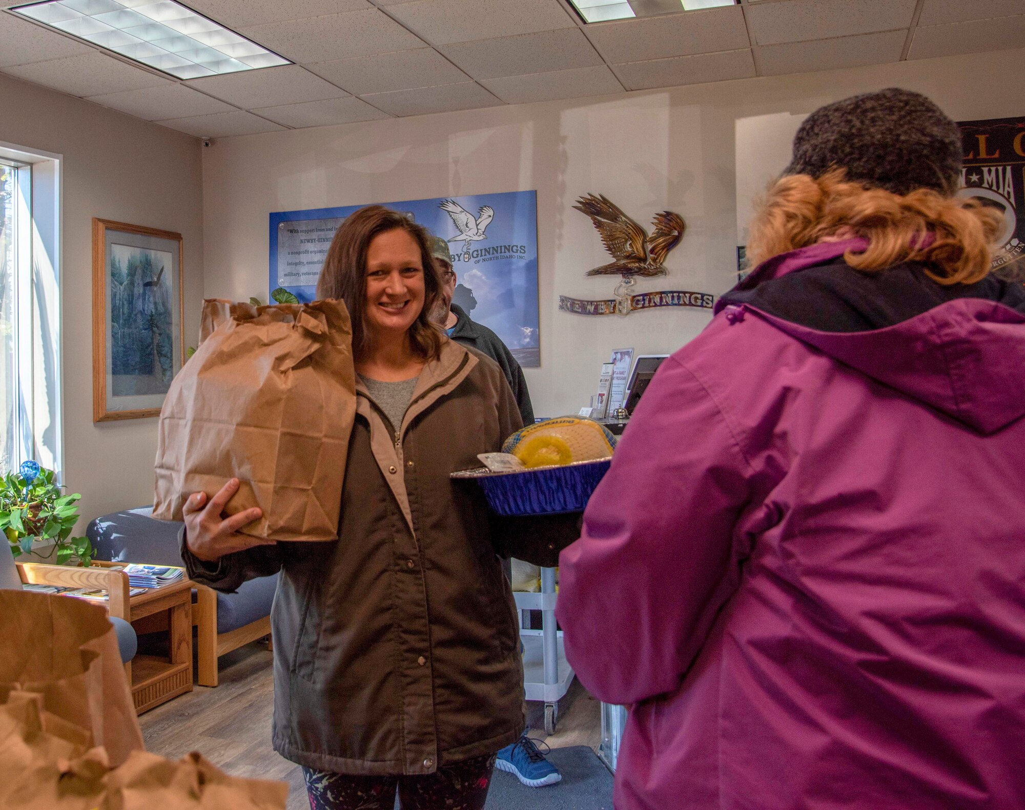 A member of the local community receives a Thanksgiving meal bag and turkey at Newby-ginnings in Post Falls, Idaho, Nov. 14, 2019.