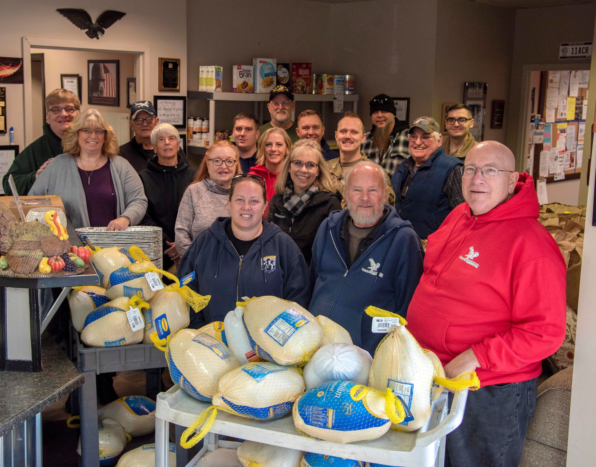 Veterans, active duty Airmen, volunteers and Gold Star Family members pose for a group photo at Newby-ginnings in Post Falls, Idaho, Nov. 14, 2019.