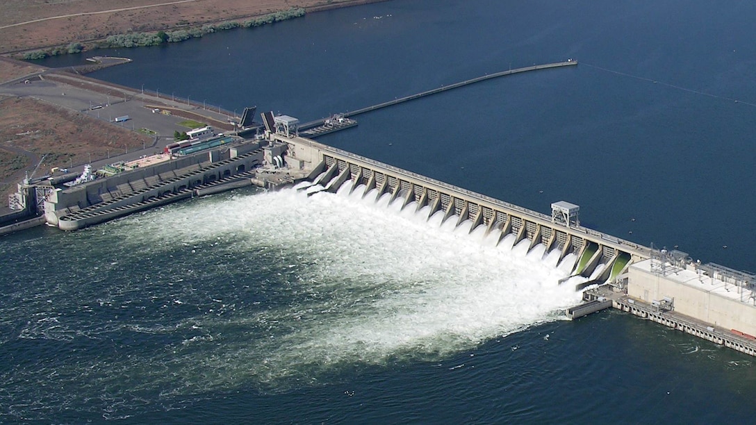 Spill through two raised spillway weirs (right) and conventional spillways at McNary Dam on the lower Columbia River improves downstream passage survival for juvenile salmon and steelhead.