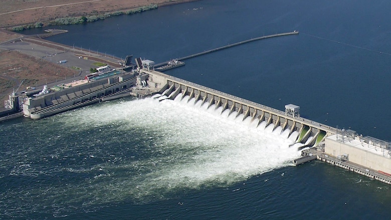 Spill through two raised spillway weirs (right) and conventional spillways at McNary Dam on the lower Columbia River improves downstream passage survival for juvenile salmon and steelhead.
