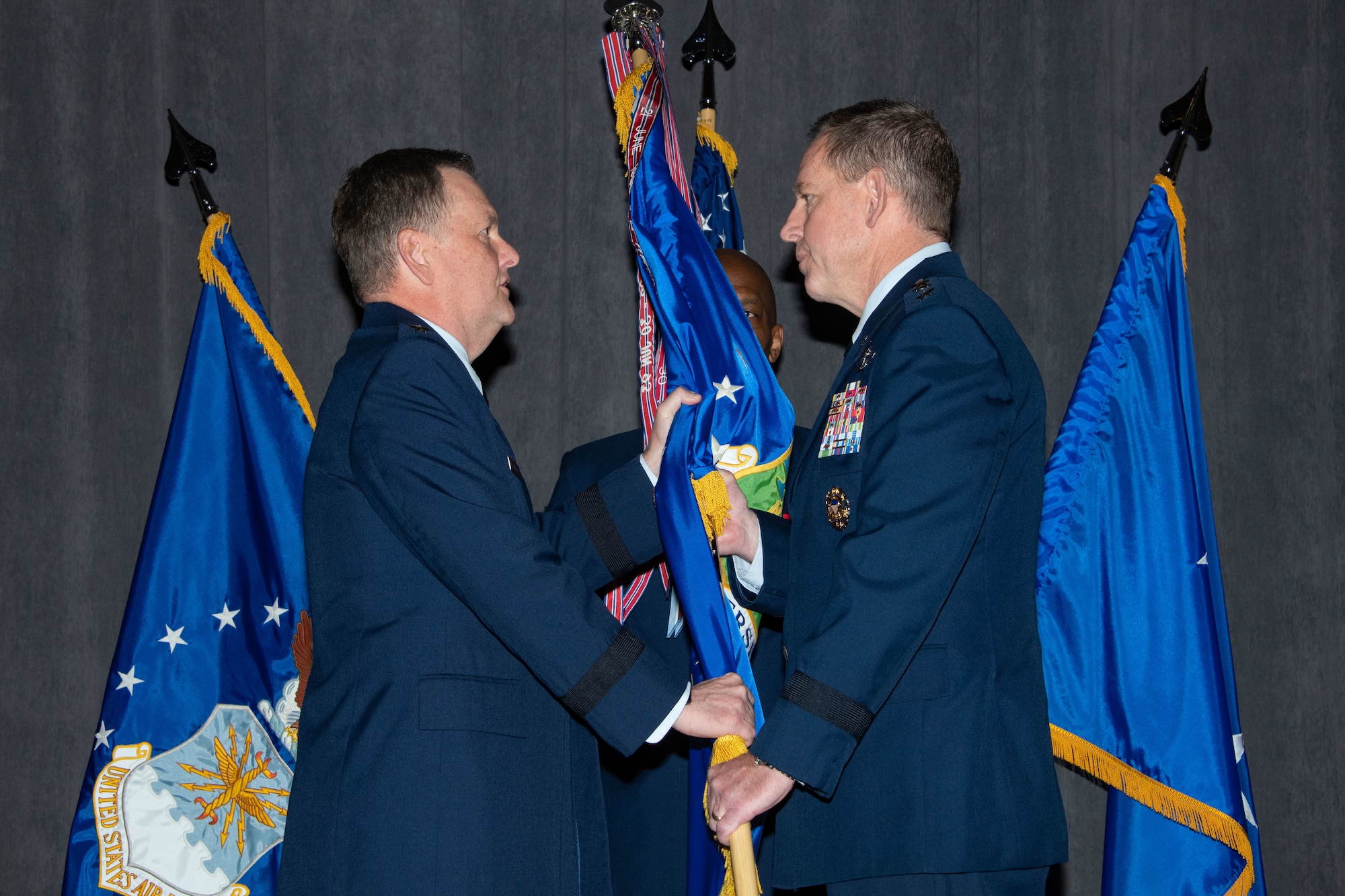 Lt. Gen. Brad Webb, commander of Air Education and Training Command, passes the guidon to Lt. Gen. James B. Hecker during an assumption of command ceremony in which Hecker takes over as the commander and president of Air University Nov. 22, 2019, at Maxwell Air Force Base, Alabama. The AU provides full spectrum education, research and outreach at every level through professional military education, professional continuing education and academic degree granting.