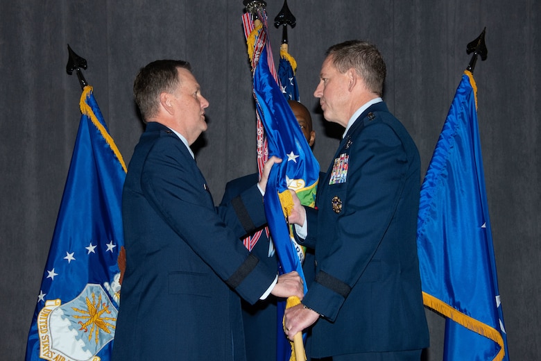 Lt. Gen. Brad Webb, commander of Air Education and Training Command, passes the guidon to Lt. Gen. James B. Hecker during an assumption of command ceremony in which Hecker takes over as the commander and president of Air University Nov. 22, 2019, at Maxwell Air Force Base, Alabama. The AU provides full spectrum education, research and outreach at every level through professional military education, professional continuing education and academic degree granting.