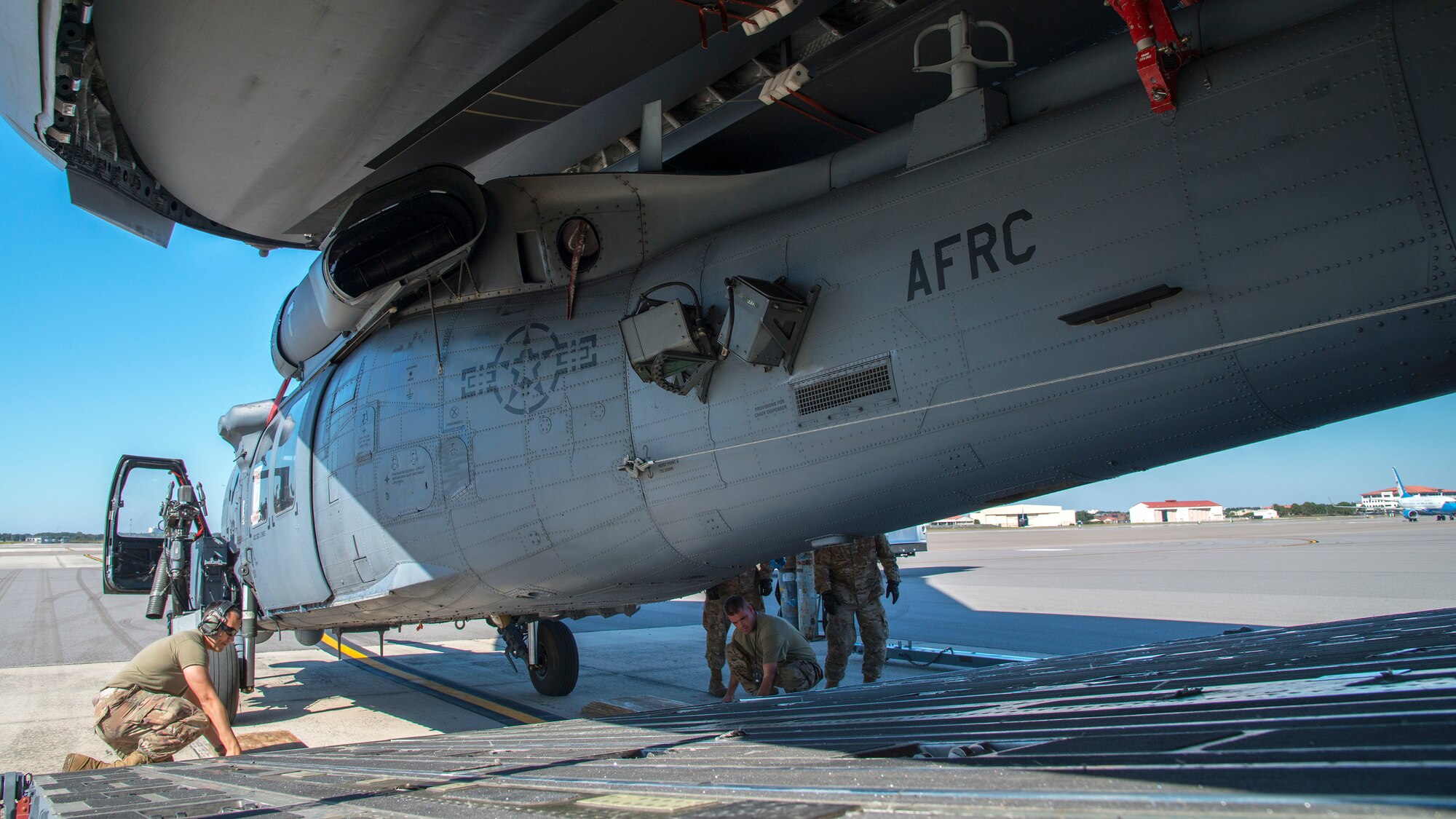 Air Mobility Command and U.S. Air Force Reserve Airmen upload an HH-60 Pave Hawk helicopter assigned to the 305th Rescue Squadron (RQS), Davis-Monthan Air Force Base, Ariz., onto a C-17 Globemaster III assigned to the 445th Airlift Wing (AW), Wright-Patterson Air Force Base, Ohio., at MacDill Air Force Base, Fla., Nov. 20, 2019.