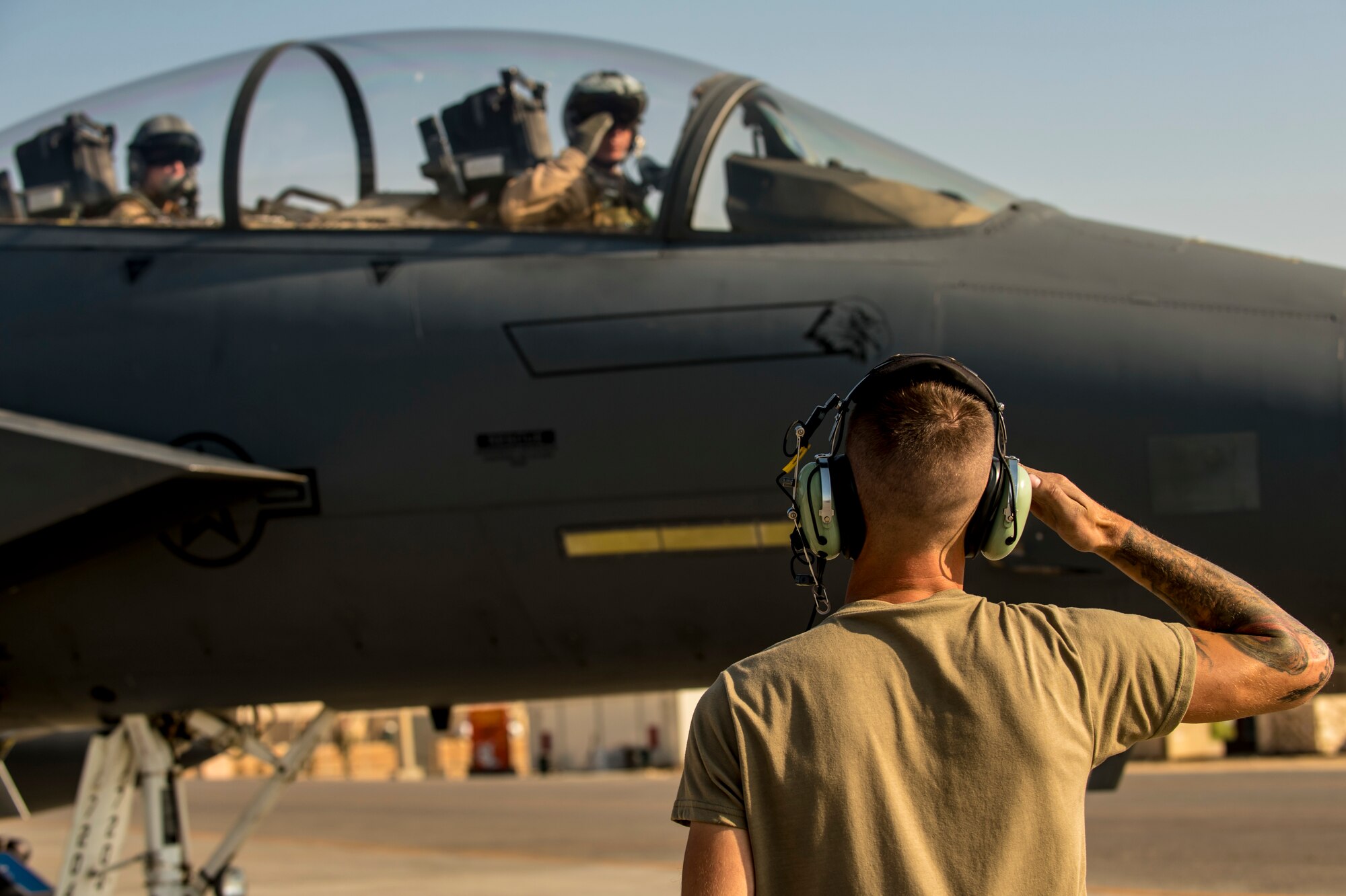 Airman marshals an F-15E Strike Eagle