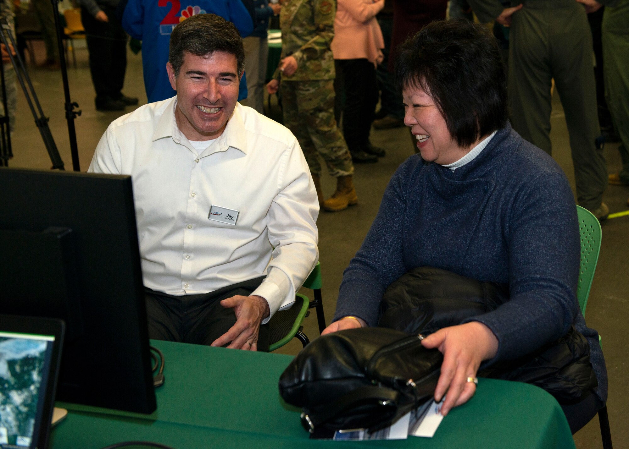 Jay Austin, an environmental analyst with Leidos, talks about noise contours with Carol Wong, an Anchorage resident, during an Air Installation Compatible Use Zone study open house in Anchorage, Alaska, Nov. 20, 2019. Joint Base Elmendorf-Richardson, Alaska, hosted the event, which showed the results of the study, to promote transparency between the installation and its community partners.