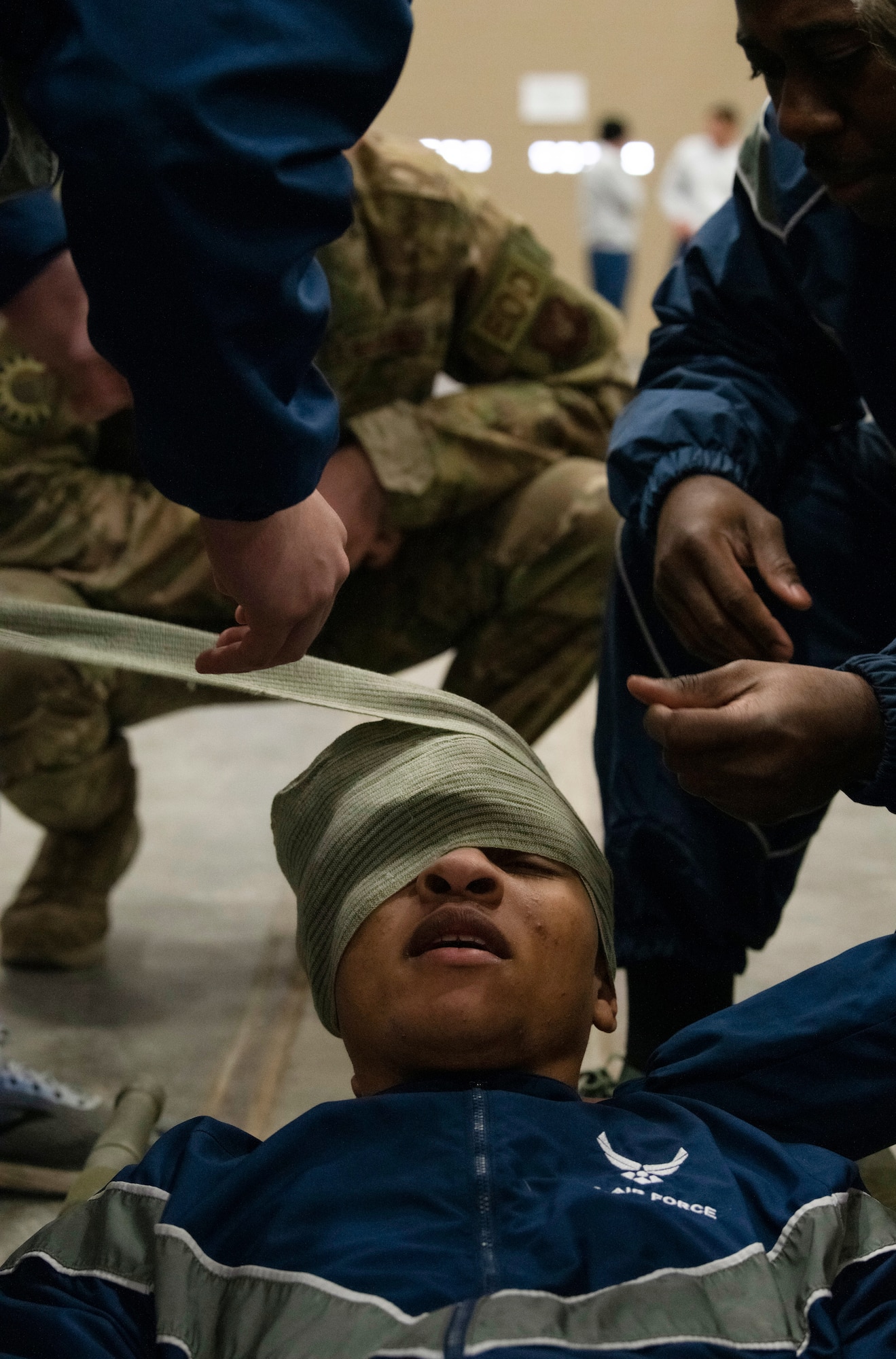 Airmen from the 90th Mission Support Group practice Self Aid Buddy Care skills during a friendly evaluation as part of a quarterly Warrior Day Nov. 21, 2019, on F.E. Warren Air Force Base, Wyo. The day’s events consisted of physical fitness, Self Aid Buddy Care skills, Chemical Biological Radiological Neurological evaluation, and Air Force knowledge, with 14 teams comprised of 90th MSG Airmen. (U.S. Air Force photo by Senior Airman Abbigayle Williams)