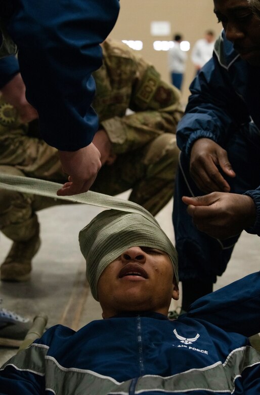 Airmen from the 90th Mission Support Group practice Self Aid Buddy Care skills during a friendly evaluation as part of a quarterly Warrior Day Nov. 21, 2019, on F.E. Warren Air Force Base, Wyo. The day’s events consisted of physical fitness, Self Aid Buddy Care skills, Chemical Biological Radiological Neurological evaluation, and Air Force knowledge, with 14 teams comprised of 90th MSG Airmen. (U.S. Air Force photo by Senior Airman Abbigayle Williams)