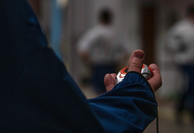 A 90th Mission Support Group Warrior Day evaluator times Airmen as they run a 400 meter relay Nov. 21, 2019, on F.E. Warren Air Force Base, Wyo. The events of this Warrior Day were timed, evaluated and given a score in order to rank each team and determine a winner of the warrior ethos challenge. (U.S. Air Force photo by Senior Airman Abbigayle Williams)