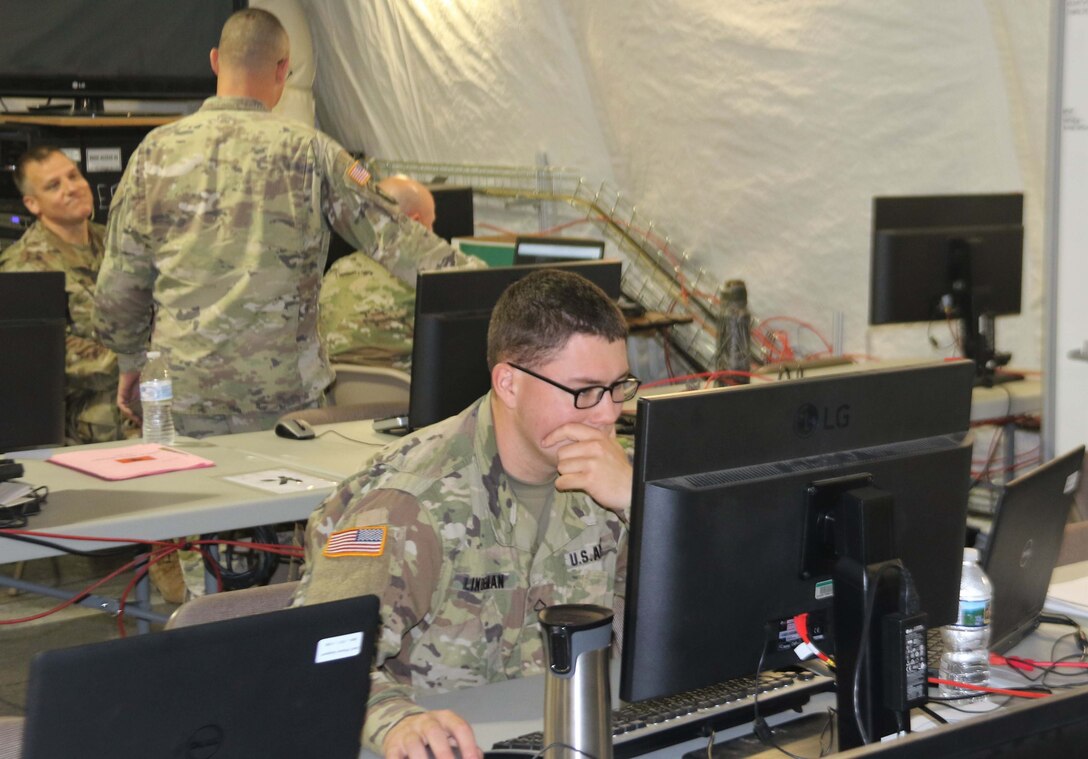 Soldiers work on computers.