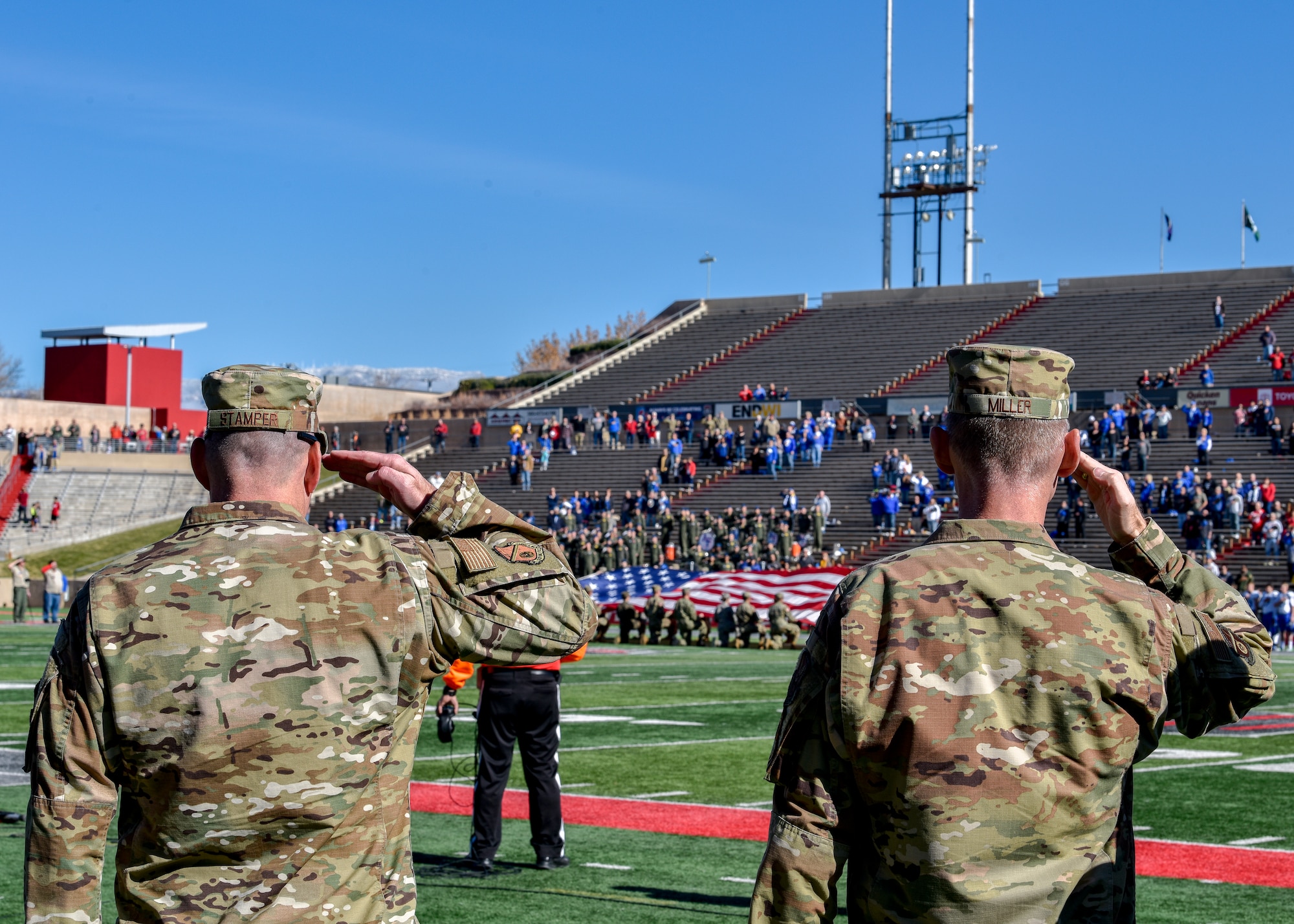 U.S. Air Force service members salute the U.S. flag.