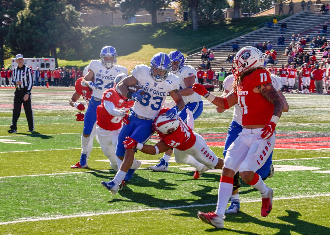 Photo of a football player running the ball.