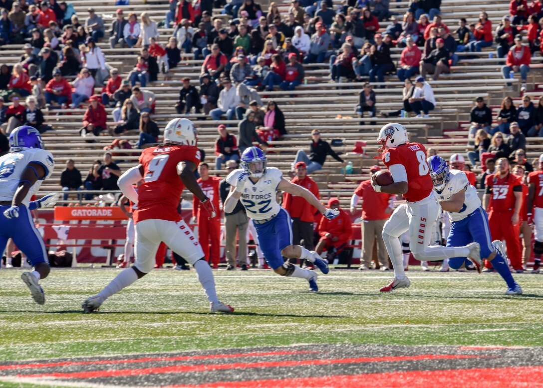 Photo of a quarterback running the football.