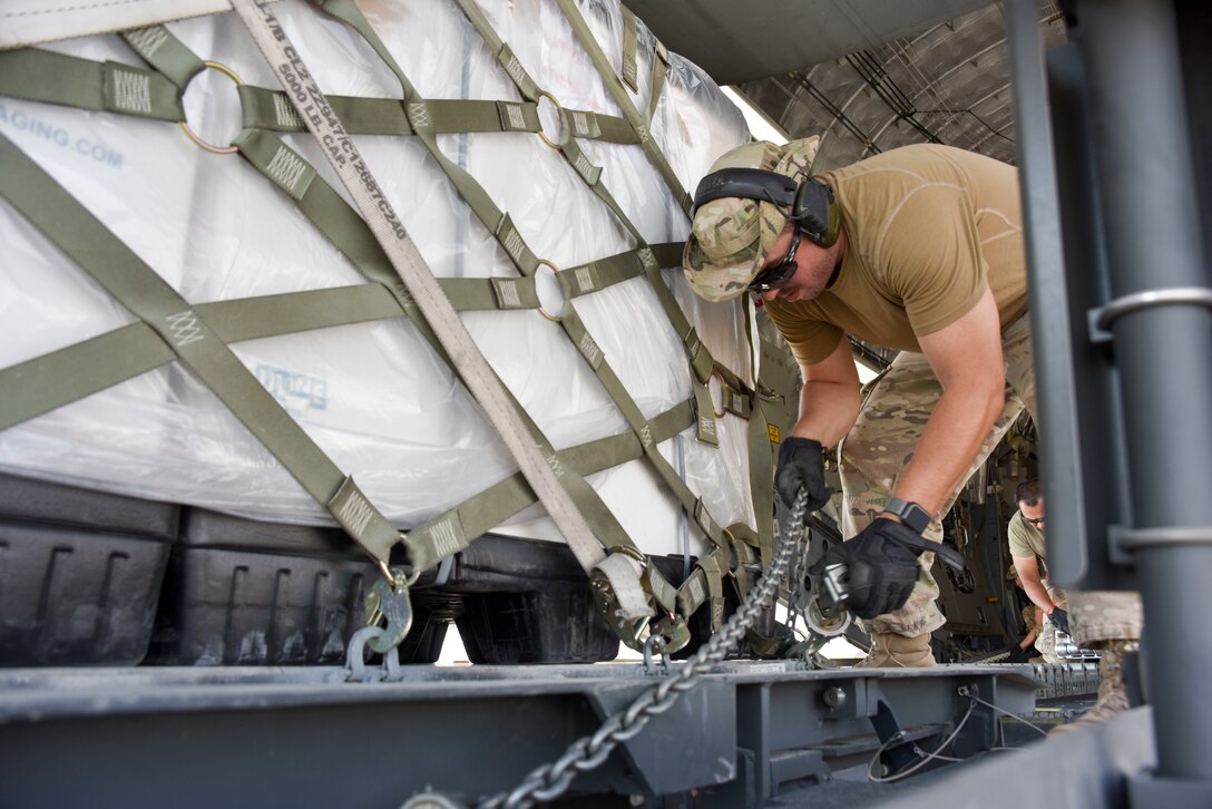 Staff Sgt. Robert Bonte, 378th Air Expeditionary Group air transportation specialist, secures a strap while downloading equipment from a C-17 Globemaster III at Prince Sultan Air Base, Saudi Arabia on Nov. 7, 2019. PSAB will serve as a strategic operating location for U.S. Air Forces Central Command and U.S. Central Command and fills a mutually beneficial role of countering destabilizing regional activity. (U.S. Air Force photo by Tech. Sgt. John Wilkes)