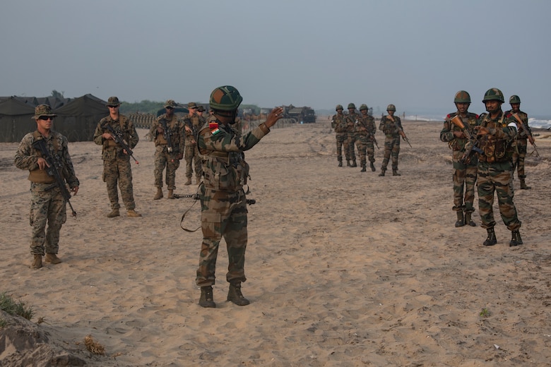 U.S. Marines and Indian Soldiers conduct patrol drills during exercise Tiger TRIUMPH in Kakinada Beach, India on November 19, 2019. The drills were to teach U.S. Marines and Indian Soldiers how each country patrols and use hand signals. Tiger TRIUMPH gives U.S. and Indian forces the opportunity to exchange knowledge and learn from each other as well as establish personal and professional relationships. The Marines are with 3rd Marine Division, III Marine Expeditionary Force. (U.S. Marine Corps photo by Lance Cpl. Armando Elizalde)