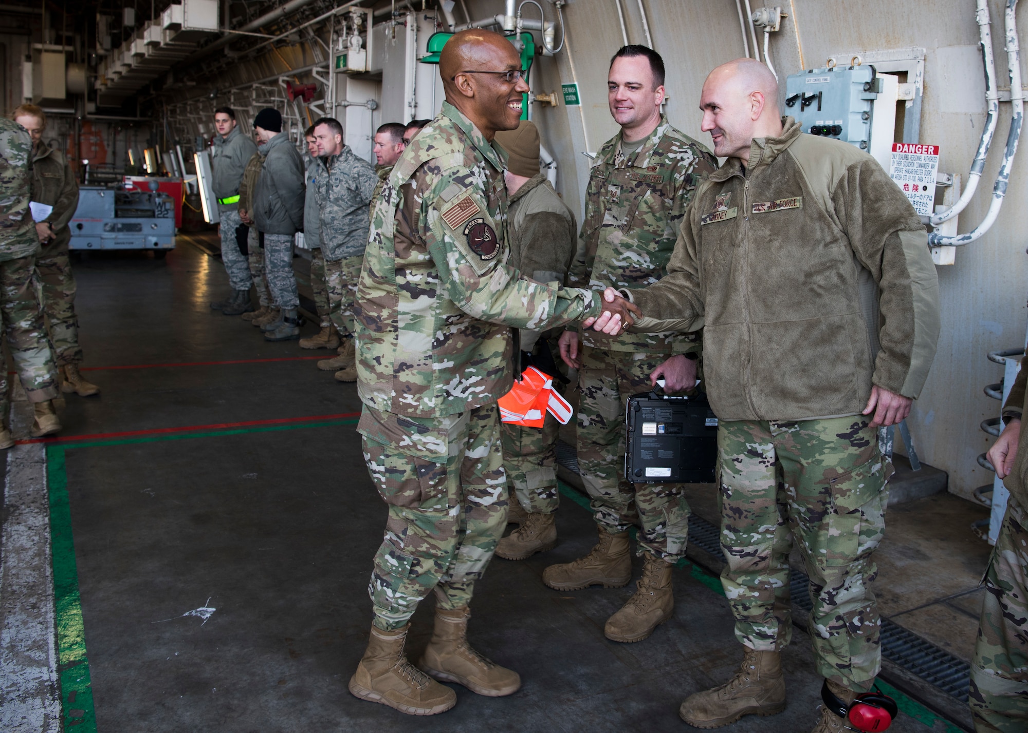 U.S. Air Force Gen. CQ Brown Jr., Pacific Air Forces commander, shakes hands with Master Sgt. Edward Abney, 35th Maintenance Group loading standardization crew chief, at Misawa Air Base, Japan, Nov. 14, 2019. Brown’s base tour included meeting with Team Misawa members from various units to better understand the capabilities and responsibilities each shop contributes to the “fight tonight” mentality in the Indo-Pacific. (U.S. Air Force Photo by Senior Airman Collette Brooks)
