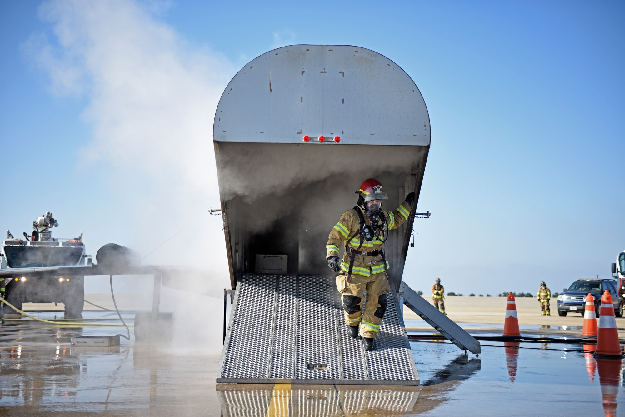 A U.S. Air Force firefighter assigned to the 8th Civil Engineer Squadron exits an aircraft fire trainer during a live fire simulation at Kunsan Air Base, Republic of Korea, Nov. 20, 2019. Live fire training ensures active duty firefighters are prepared for emergencies on the installation while also maintaining readiness. (U.S. Air Force photo by Staff Sgt. Mackenzie Mendez)
