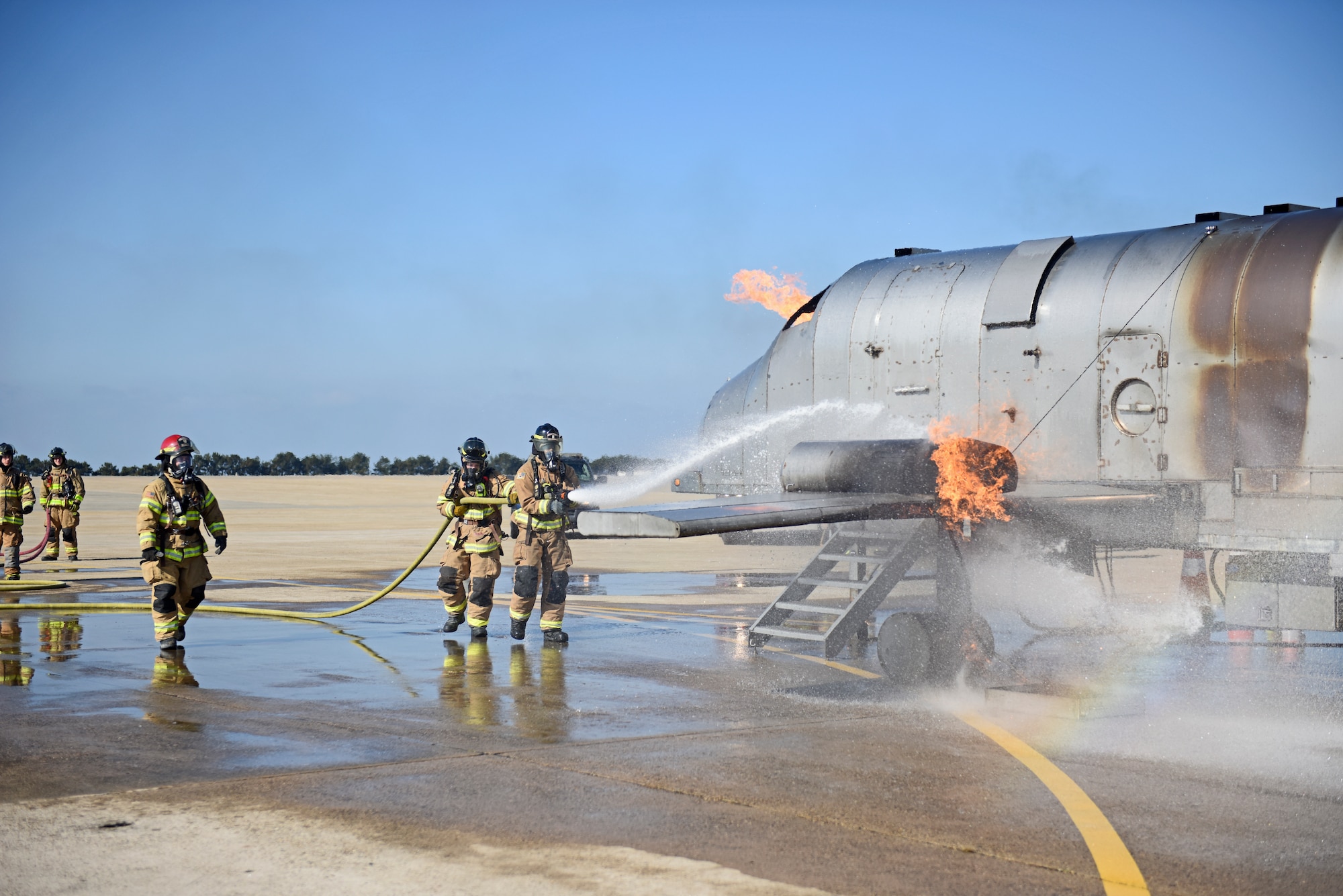U.S. Air Force firefighters assigned to the 8th Civil Engineer Squadron conduct live aircraft fire training at Kunsan Air Base, Republic of Korea, Nov. 20, 2019. Live aircraft fire training ensures 8th CES firefighters are proficient in the steps needed to properly fight aircraft fires. (U.S. Air Force photo by Staff Sgt. Mackenzie Mendez)