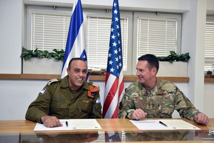 Israeli Maj. Gen. Tamir Yadaie, commanding general, Home Front Command, and Air Force Gen. Joseph Lengyel, chief, National Guard Bureau, prepare to sign the reaffirmation of a longstanding bilateral relationship between the HFC and the National Guard Bureau, Tel Aviv, Israel, Nov. 14, 2019.