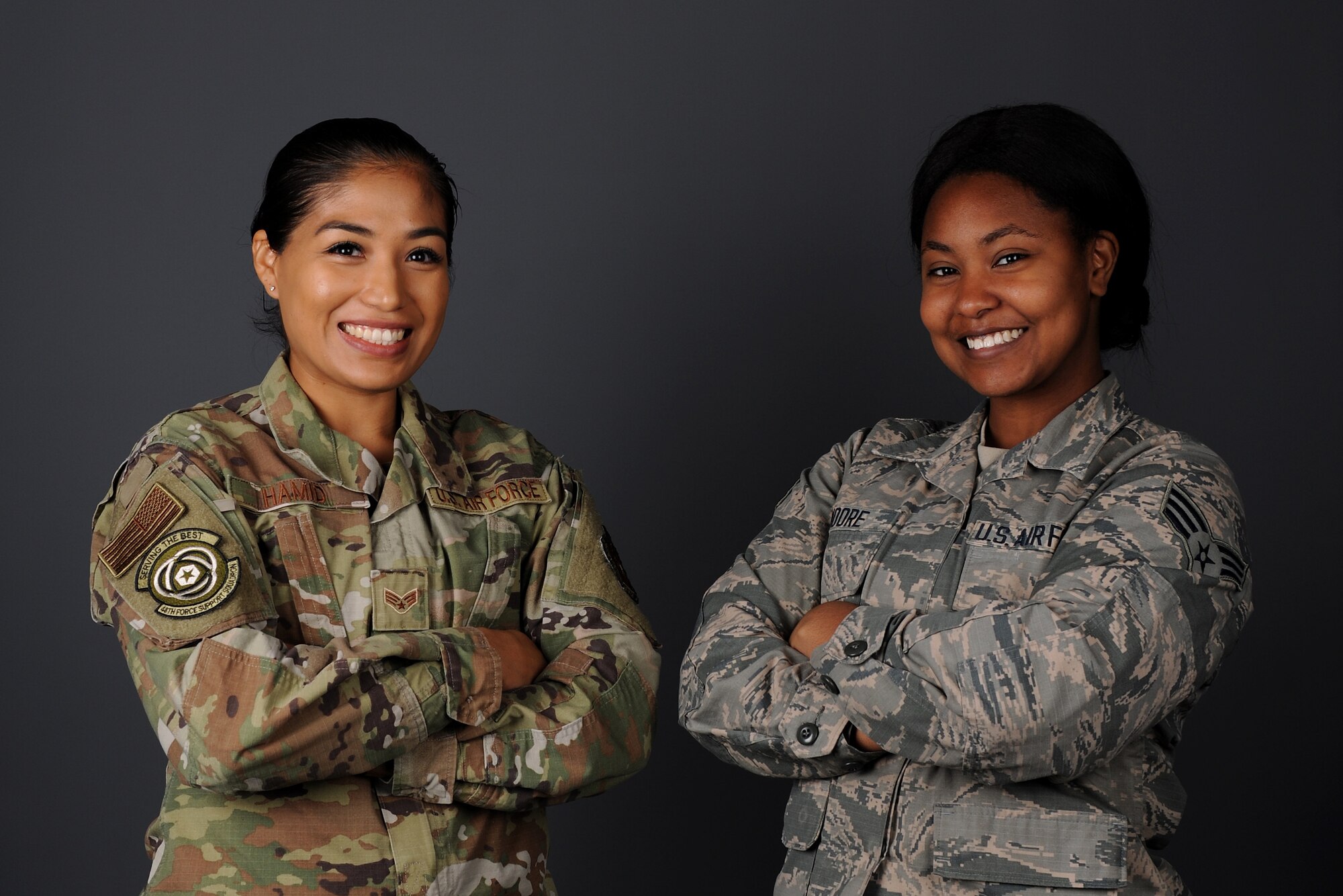 Senior Airman Gladiola Hamid, 48th Force Support Squadron unit deployment manager, left, and Senior Airman Gabrielle Moore, 48th FSS military postal clerk, right, pose for photo at Royal Air Force Lakenheath, England, Nov. 18, 2018. Hamid and Moore provided rescue aid to Spanish civilians involved in a three-car collision near the town of Mogán en-route to Gando Air Base in Gran Canaria, Spain. (U.S. Air Force photo by Airman 1st Class Rhonda Smith)