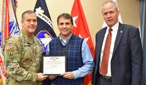 Lt. Gen. James H. Dickinson, commanding general, U.S. Army Space and Missile Defense Command, presents John C. Schocke, USASMDC headquarters deputy chief of staff, for the technical/technical management category, with the command’s 2019 Civilians of the Year for technical/technical management category award during a ceremony Nov. 20 at the command’s Redstone Arsenal, Alabama, headquarters. (U.S. Army photo by Ronald Bailey)