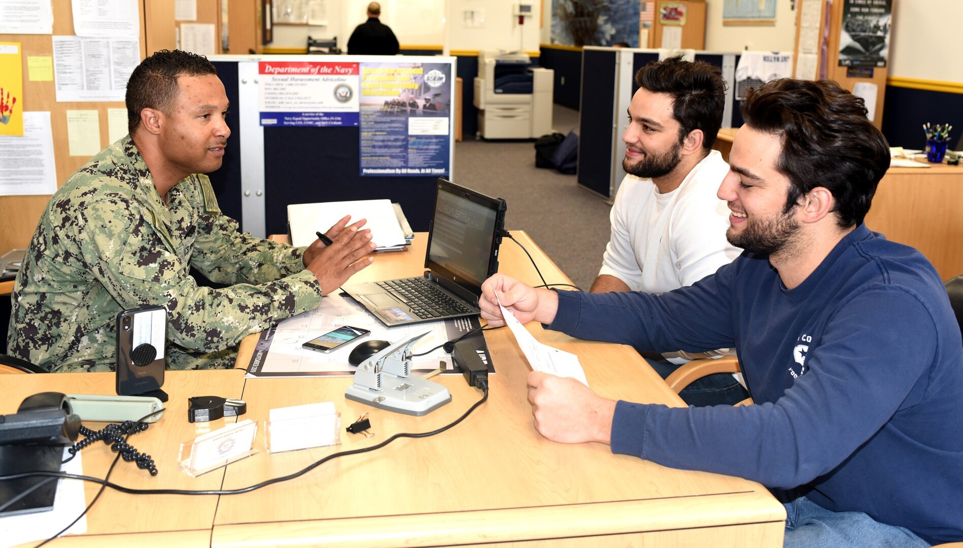 Petty Officer 1st Class Russell Sylve, Navy Recruiting Station  Mercado, talks with twin brothers Stephen and George Coppage of San Antonio during a weekly Delayed Entry Program Re-certification at the NRS.  The Coppage brothers are 2011 graduates of Louis D. Brandeis High School and joined the Navy to pursue careers in aviation support. They were recruited by Petty Officer 2nd Class Brooks Anderson of NRS Mercado.