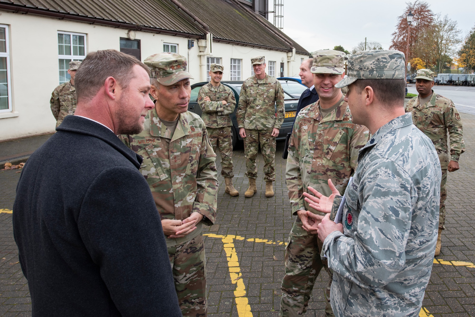 Maj. Gen. John Wilcox, Air Force Installation and Mission Support Center commander, and Chief Master Sgt. Edwin Ludwigsen, AFIMSC command chief master sergeant, speak with Airmen outside the aerospace ground equipment building Nov. 22, 2019, at RAF Mildenhall, England. The AFIMSC provides base communications, civil engineering, security forces and logistics support that assists Team Mildenhall in fulfilling its mission sets. (U.S. Air Force photo by Airman 1st Class Joseph Barron)