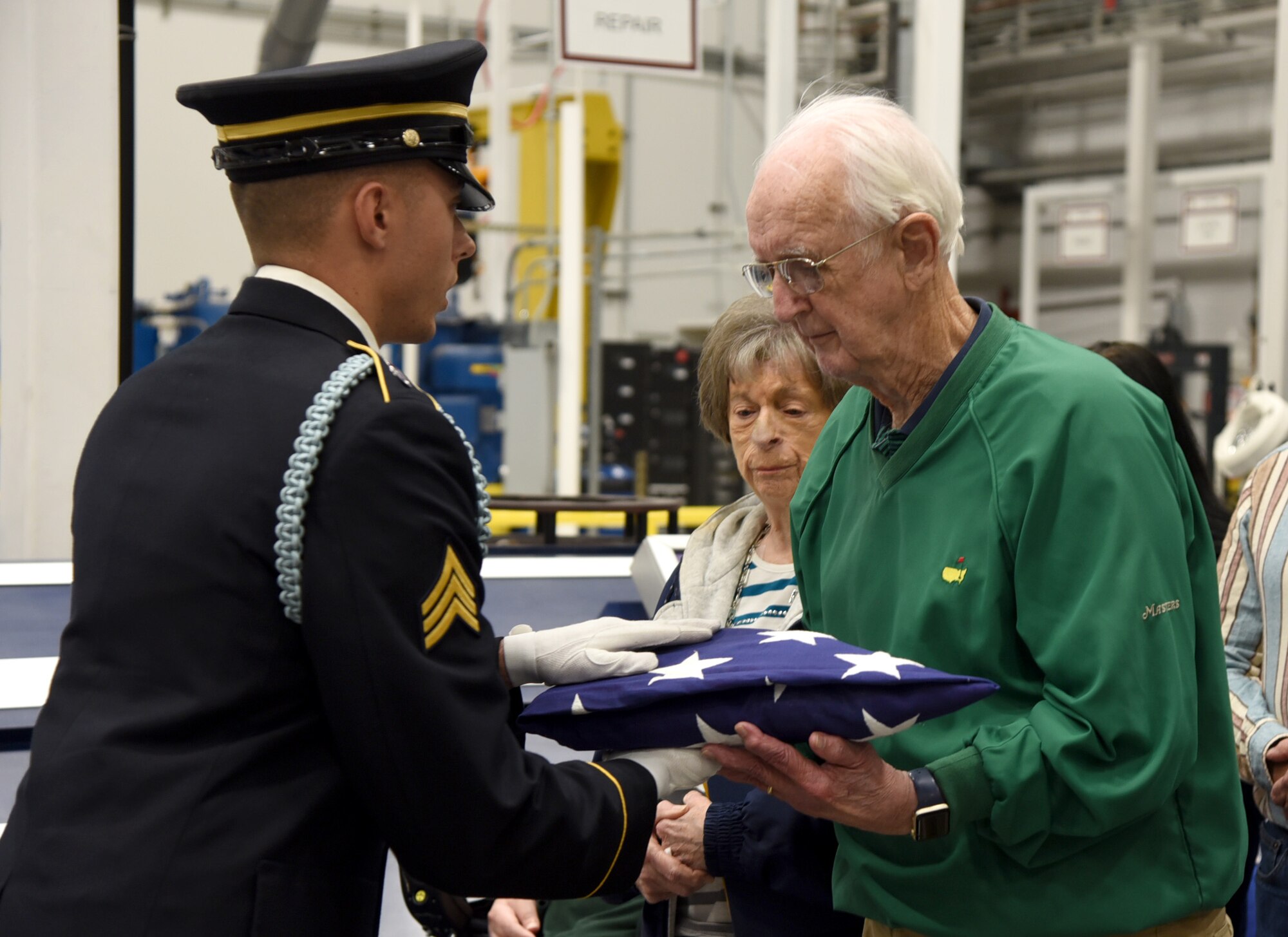 An image of Dwight Journey receiving an American flag, presented to him by the Army Honor Guard