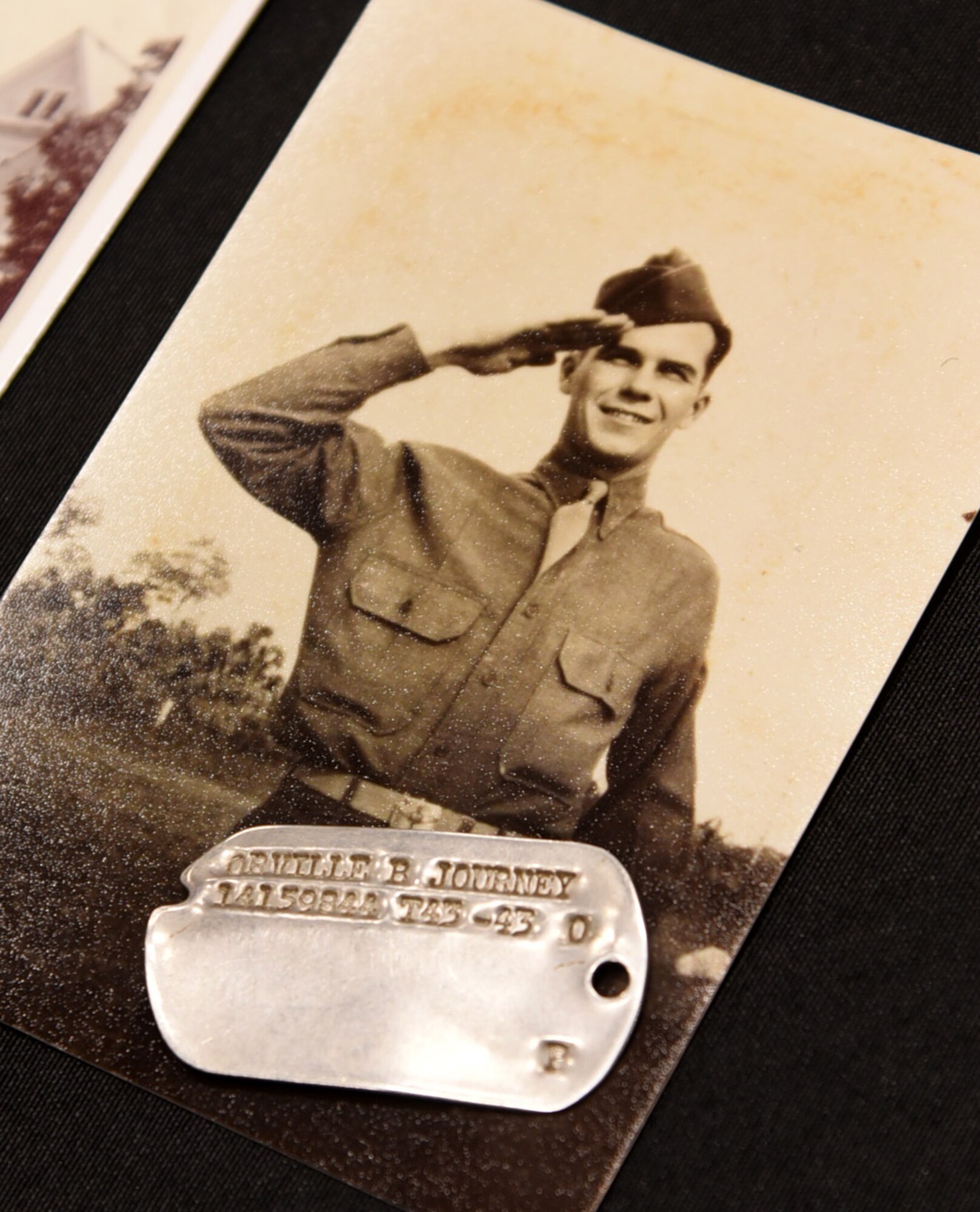 An image of TSgt. Bruce Journey during his time in service, with his recently returned dog tags