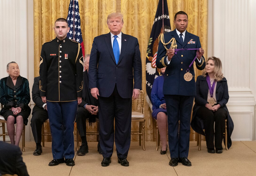 President Donald J. Trump prepares to present the National Medal of Arts to Army Staff Sgt. Jan Knutson. The guitarist with The U.S. Army Band “Pershing's Own" accepted the award on behalf of musicians of the United States military for personifying excellence in music and service to the country.