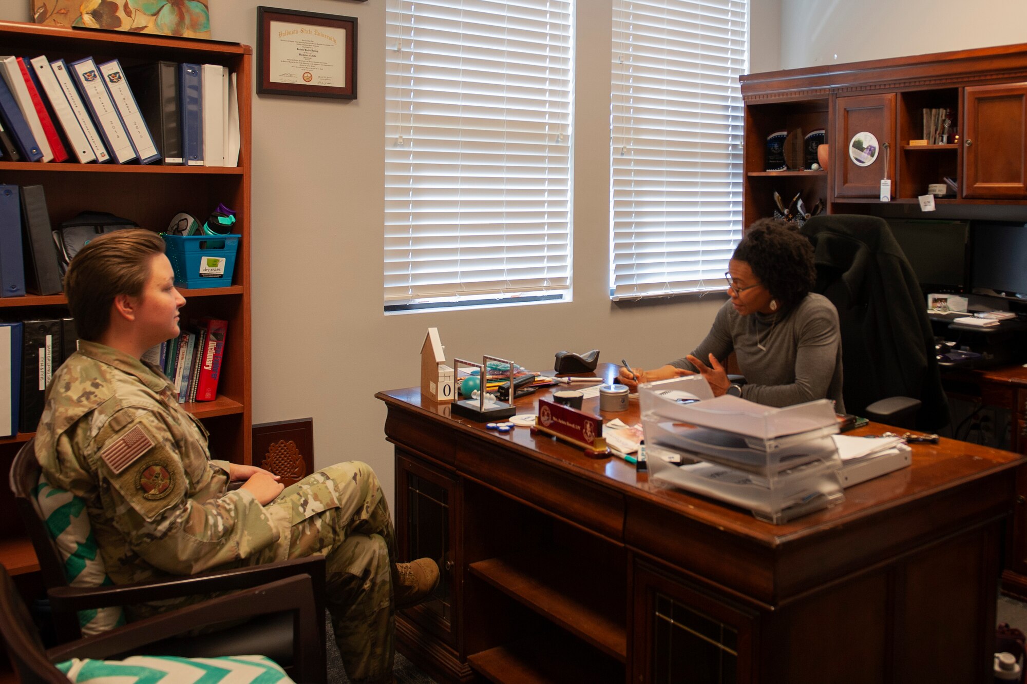 A photo of a sexual assault victim speaking with a victim advocate.