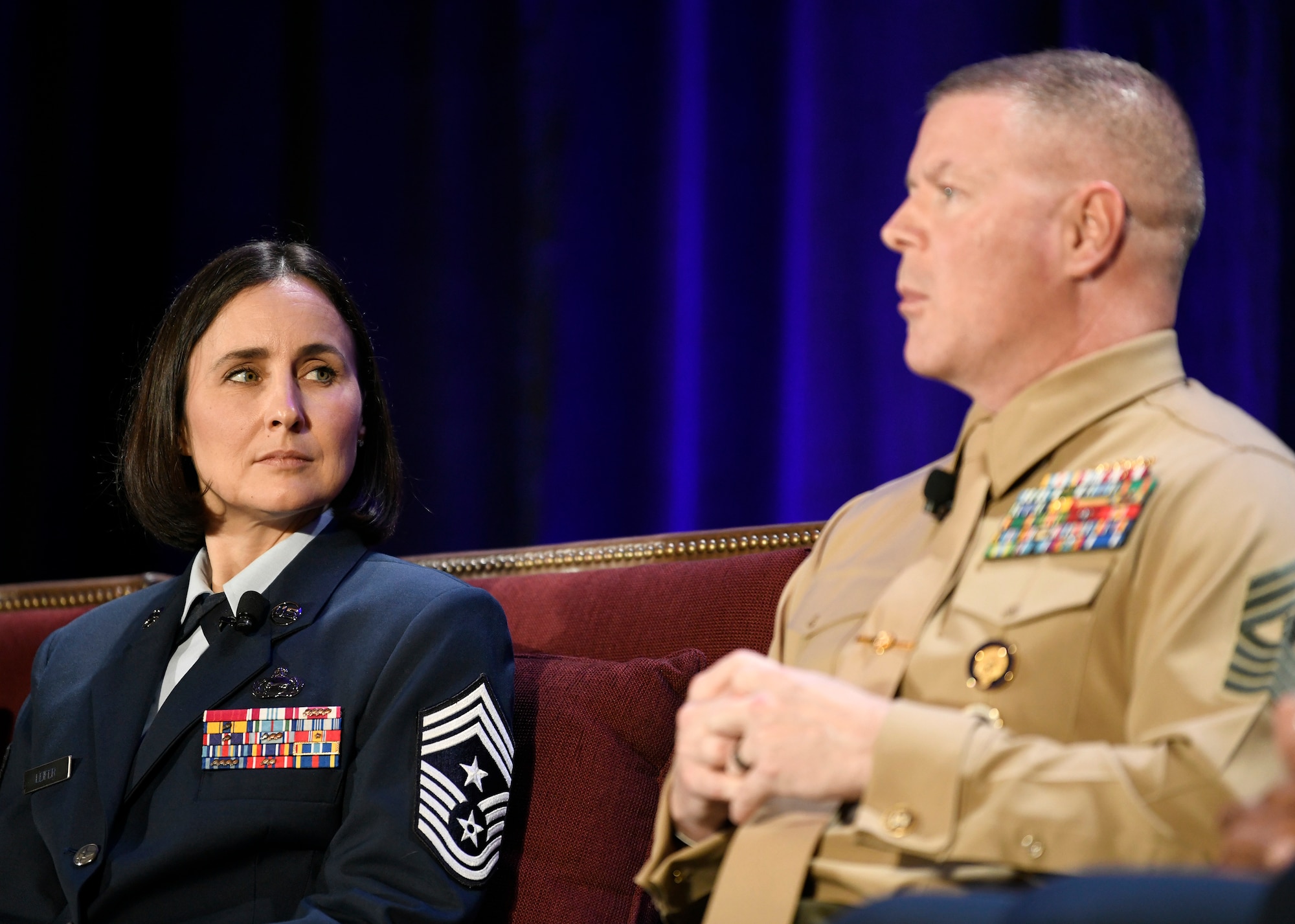 U.S. Air Force Chief Master Sgt. Summer Leifer, Sixteenth Air Force command chief, listens as U.S. Marine Corps Master Gunnery Sgt. Scott Stalker, command senior enlisted leader of U.S. Cyber Command, speaks to Alamo Armed Forces Communication and Engineering Association Chapter Event attendees in San Antonio, Texas, Nov. 20, 2019. The two sat on an SEL panel during the annual cyber- and technology-focused conference to discuss cyber enlisted matters. (U.S. Air Force photo by Tech. Sgt. R.J. Biermann)