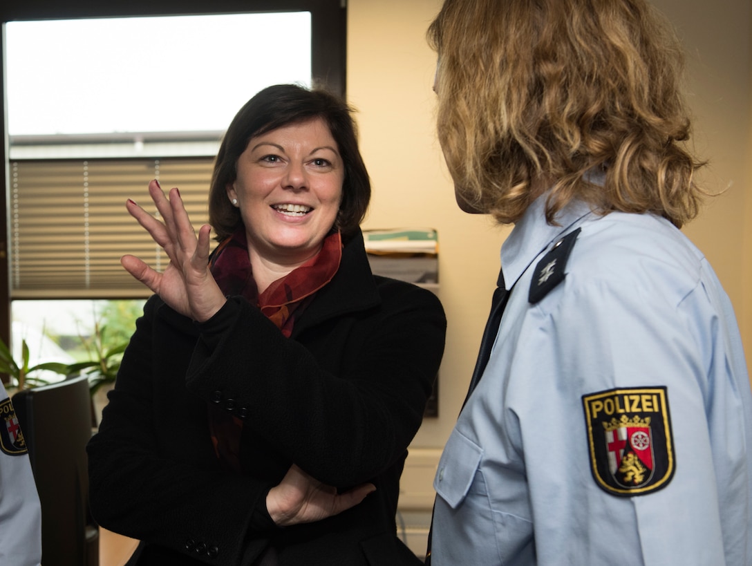 Nicole Steingaß, left, Rheinland-Palatinate state secretary, speaks with Carolyn Joas, Police Inspection Station Landstuhl police Lt., on Ramstein Air Base, Germany, Nov. 20, 2019. Steingaß received a guided tour through several stops on Ramstein, including a C-130J Super Hercules aircraft, the 721st Aerial Port Squadron Passenger Terminal, and the Sicherheitswache (German Police Station.)