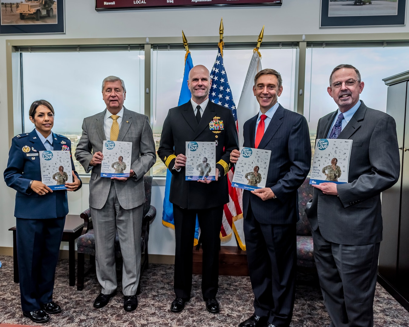 5 people standing in a group with CFC catalogs.