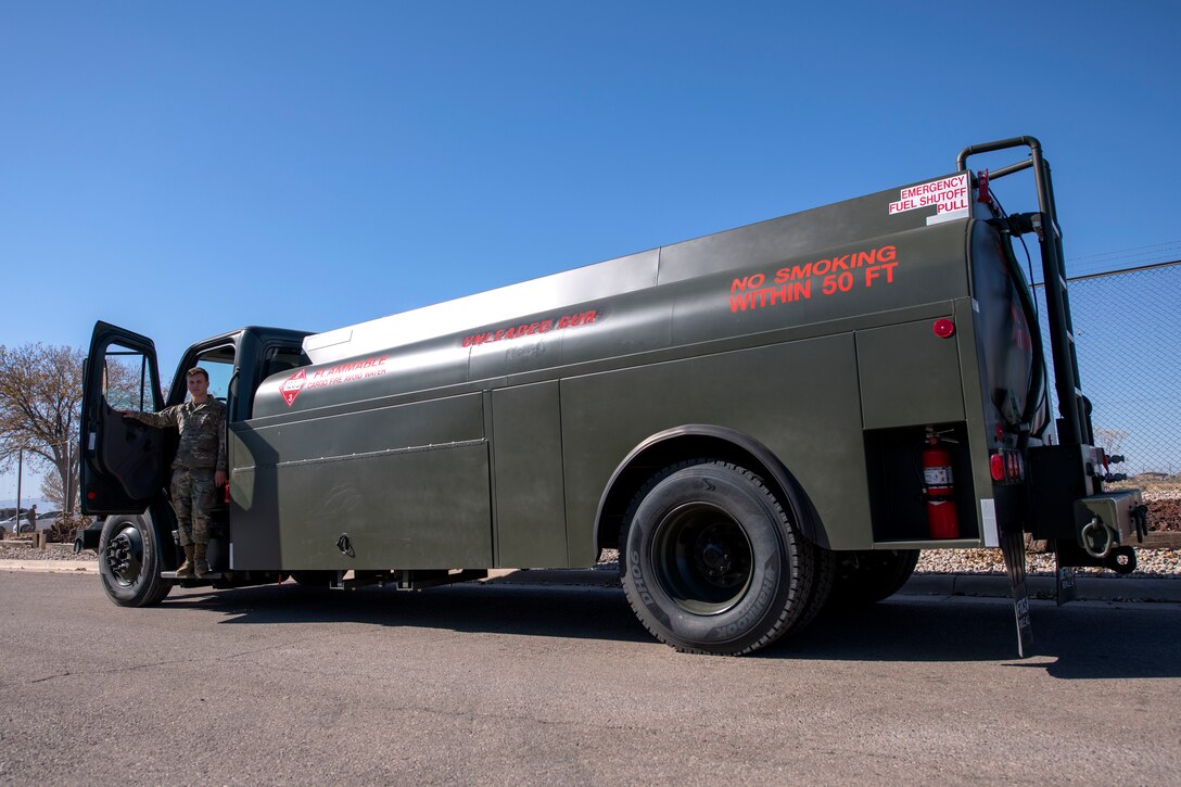 Airman 1st Class Michael Giudice, 49th Logistics Readiness Squadron fuels distribution operator, poses with an R-13 Mobile Refueling Unit Nov. 14, 2019, on Holloman Air Force Base, N.M. In fiscal year 2019, the 49th LRS provided 384,000 gallons of fuel to government vehicles as well as 14,000,000 gallons of jet fuel to assigned MQ-9 Reaper and F-16 Viper aircraft. This year alone the flight expects to save the Air Force 260 man-hours. (U.S. Air Force photo by Staff Sgt. Christine Groening)