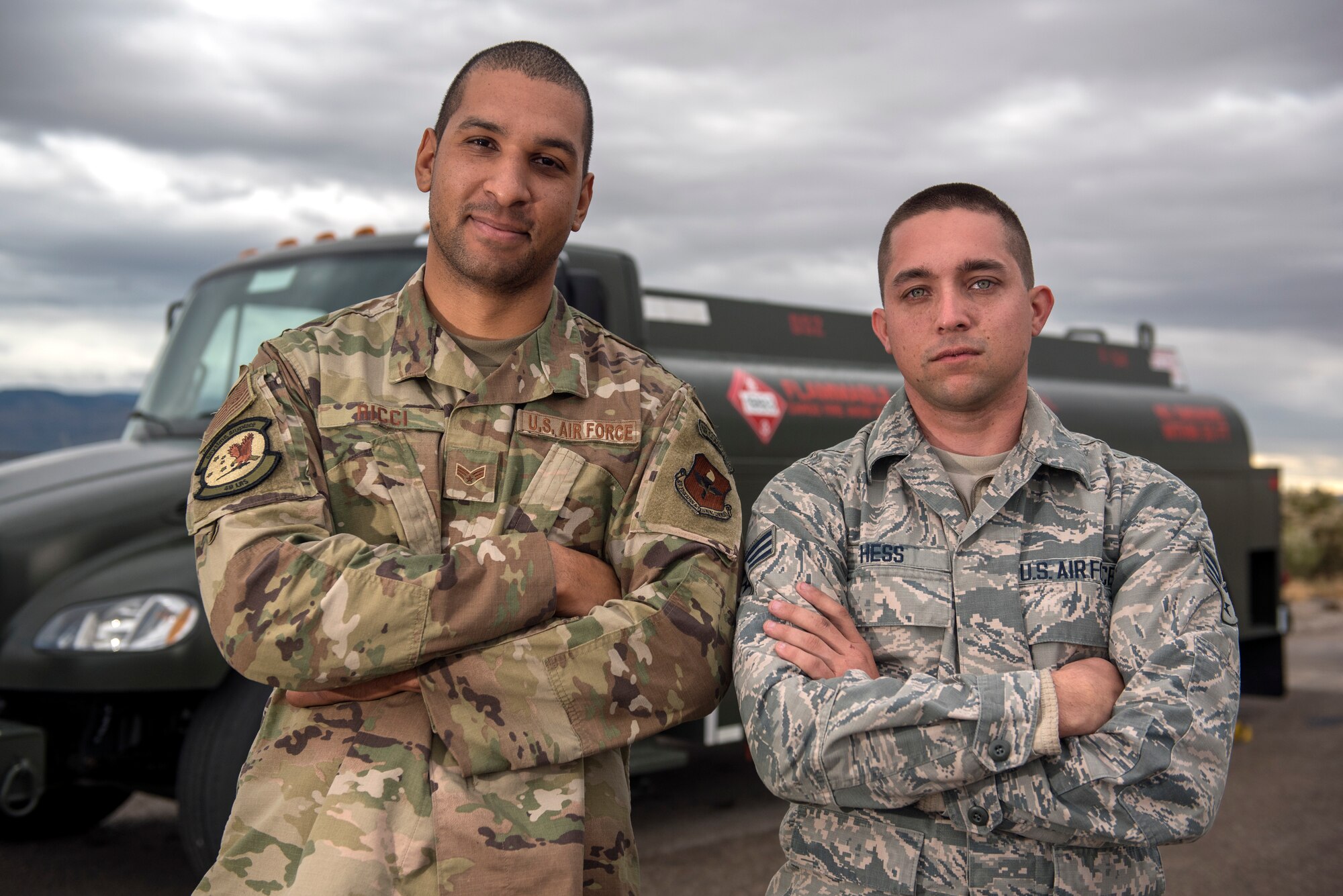 (From left to right) Senior Airman Michael Ricci and Senior Airman Joseph Hess, 49th Logistics Readiness Squadron preventive maintenance technicians, pose for a photo in front an R-13 Mobile Refueling Unit vehicle, Nov. 21, 2019, on Holloman Air Force Base, N.M. Ricci and Hess retrofitted an adapter and nozzle on the R-13 to prevent fuel commingling, the mixing of two separate products, such as gasoline in an aircraft or jet fuel into diesel vehicle. (U.S. Air Force photo by Staff Sgt. Christine Groening)