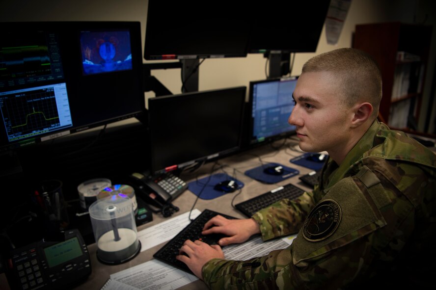 Airman 1st Class Cameron Lutz, 4th Space Operations Squadron protected satellite communications maintainer, connects to a satellite on orbit at Schriever Air Force Base, Colorado, Nov. 20, 2019. The space mission has increased, but the manpower has not prompting 4th SOPS leadership to optimize their current manpower to more efficiently and effectively execute their mission. (U.S. Air Force photo by Airman 1st Class Jonathan Whitely) (Photo was altered for security purposes by blocking a phone number)