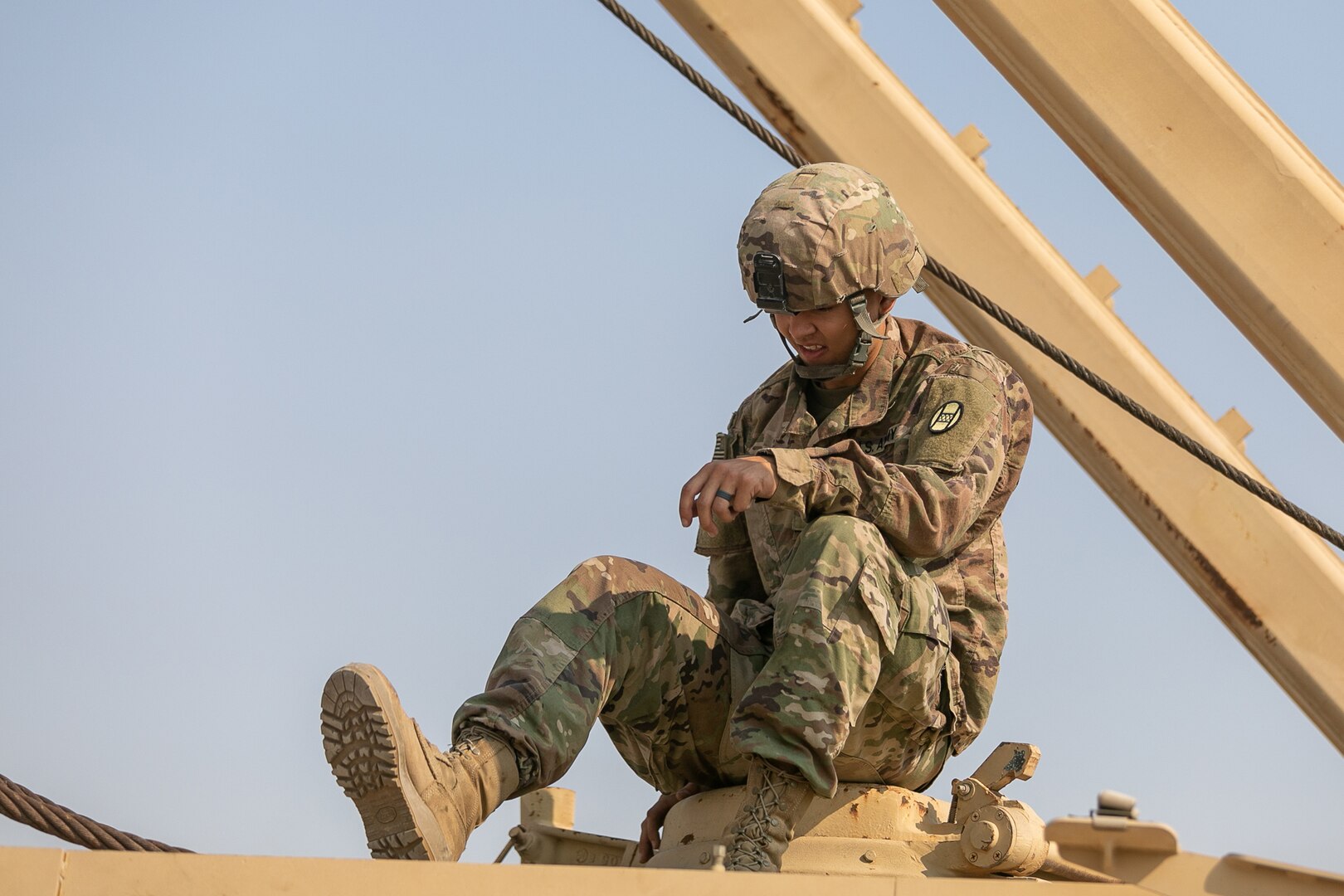 U.S. Army Spc. Roman Smith, a track mechanic in the 1-252 Armor Regiment, 30th Armored Brigade Combat Team, North Carolina Army National Guard, works on track vehicle equipment in Kuwait, Nov. 25, 2019. This is Smith’s first deployment and the first time he will be missing the holidays with his family while supporting Operation Spartan Shield.