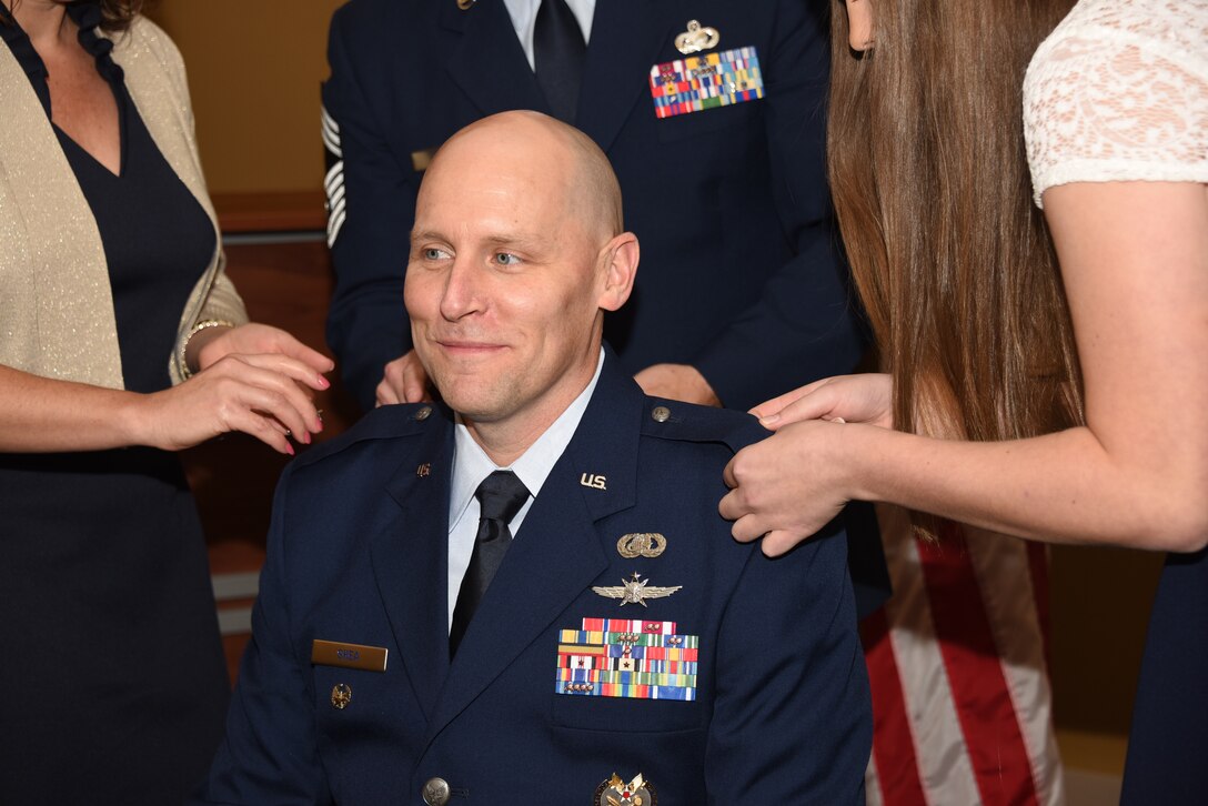 Col. Leland Shea, 911th Airlift Wing Inspector General, smiles as family members pin on his new rank during his promotion ceremony at the Pittsburgh International Airport Air Reserve Station, Pennsylvania, Nov. 2, 2019.