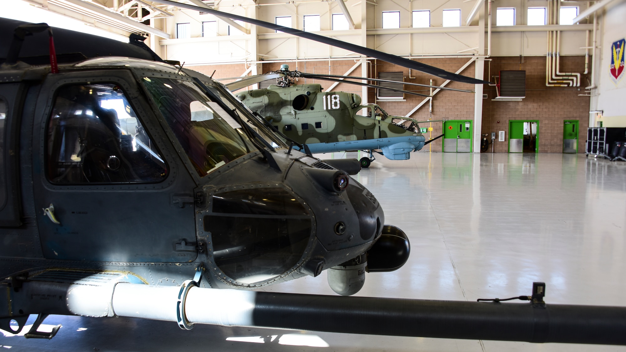 Helicopters sit in hangar