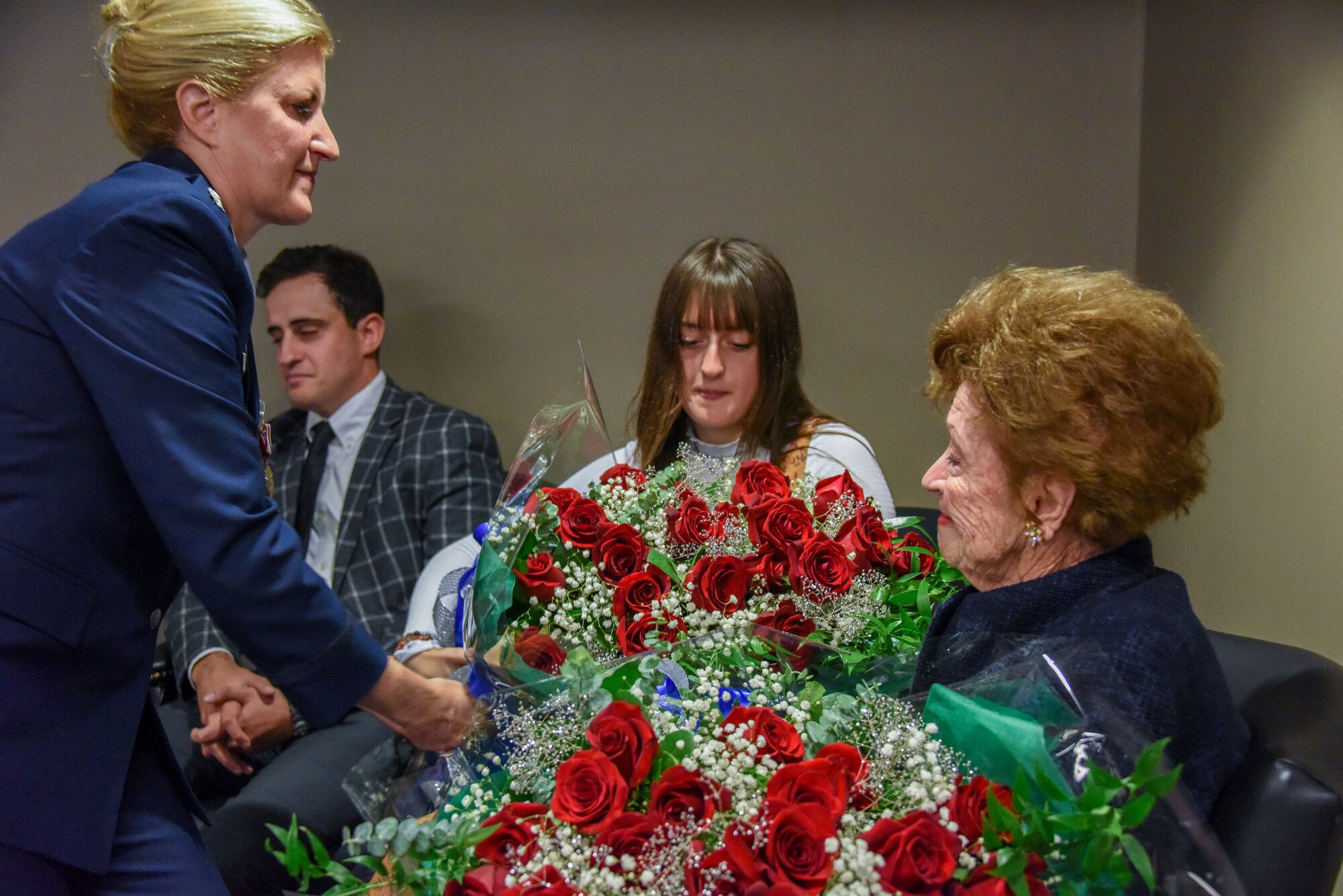 Lt. Col. Beth E. Bruker Walos, program administrator with the 911th Airlift Wing Inspector General inspections office, gives flowers to her mother during her retirement ceremony at the Pittsburgh International Airport Air Reserve Station, Pennsylvania, Nov. 2, 2019.