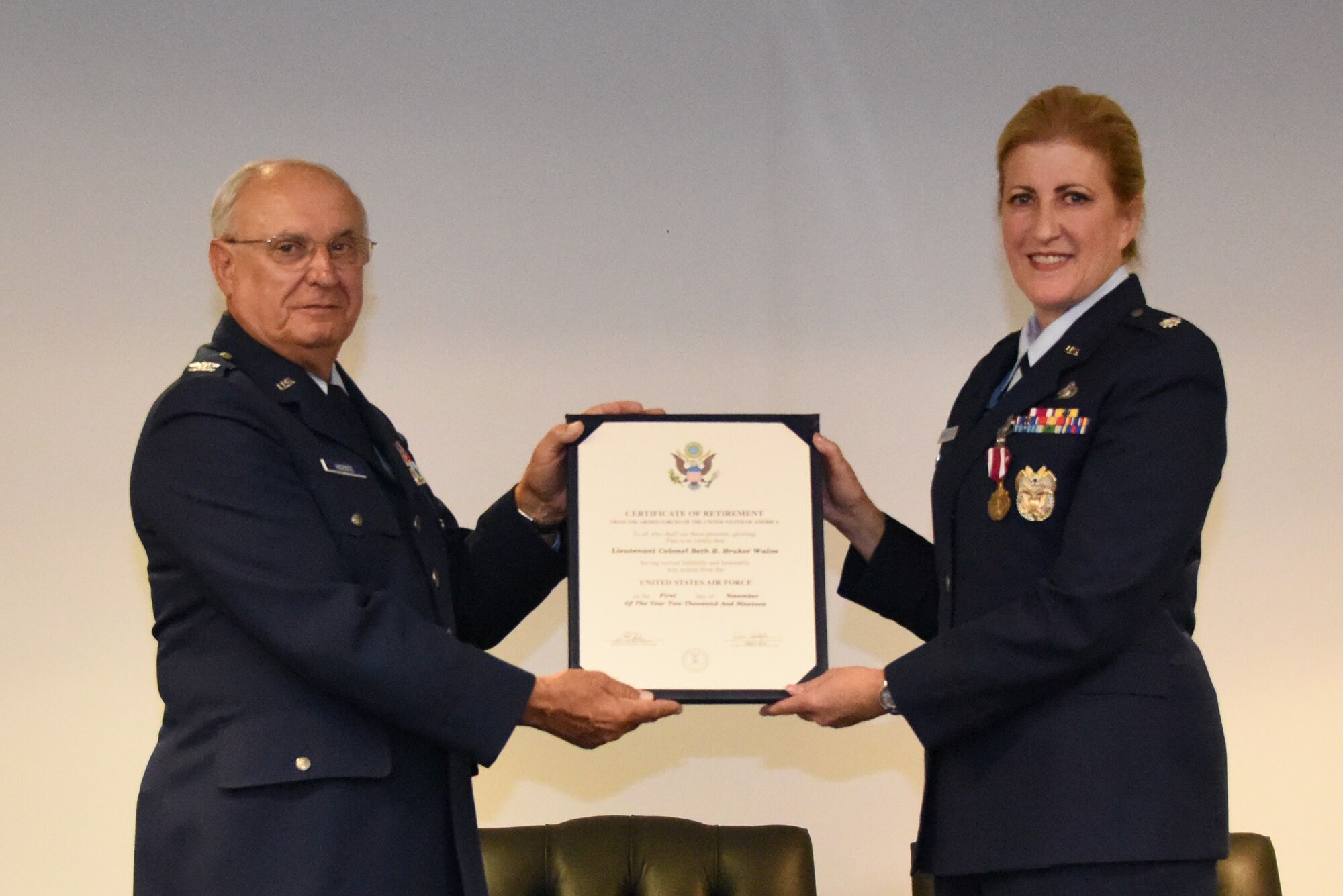 Lt. Col. Beth E. Bruker Walos, program administrator with the 911th Airlift Wing Inspector General inspections office, poses for a photo with Col. (Ret.) Frank Vicente during her retirement ceremony at the Pittsburgh International Airport Air Reserve Station, Pennsylvania, Nov. 2, 2019.