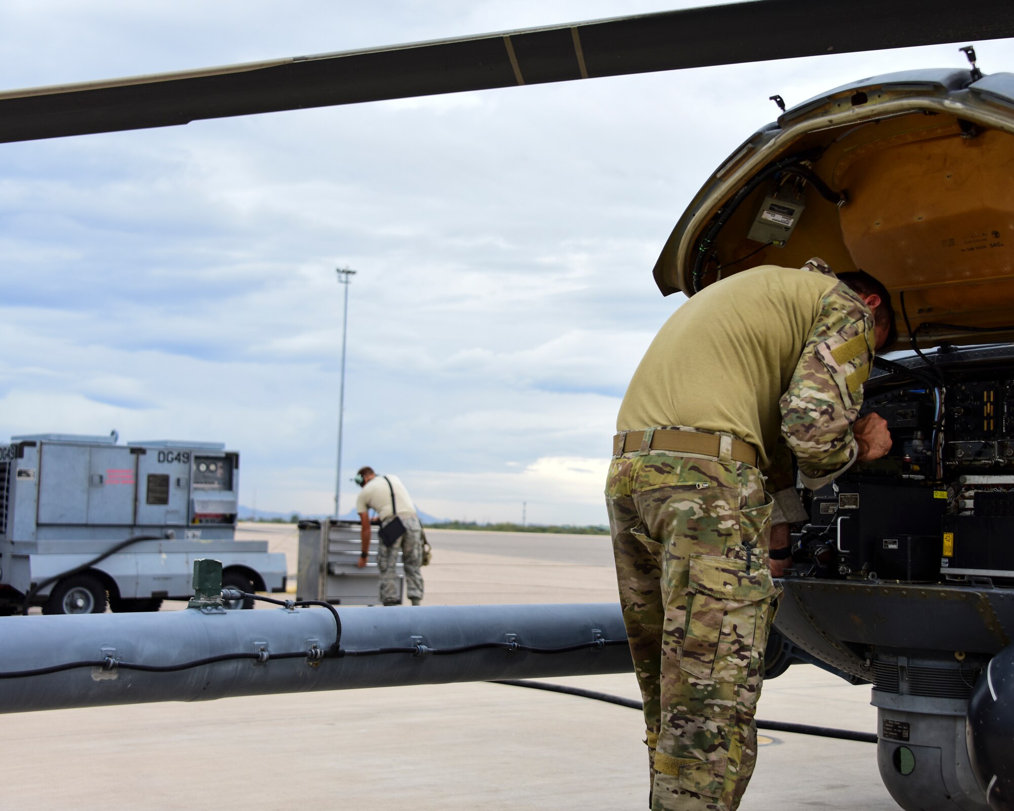 Airmen work on HH-60