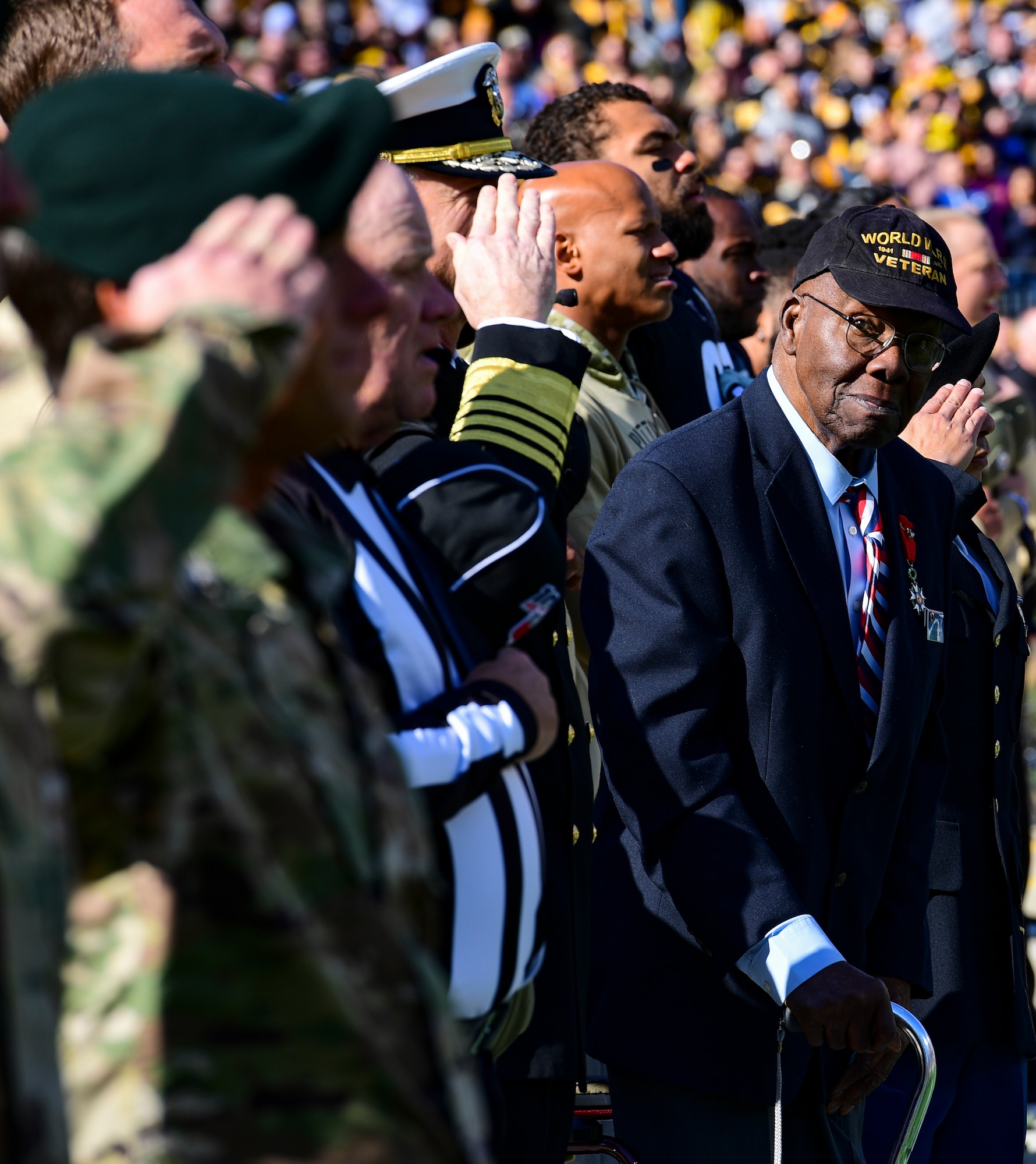 World War II veteran Henry Parham looks on as Admiral Craig S. Faller, U.S. Navy Southern Command combatant commander and members of the U.S. Army salute during the National Anthem at a Pittsburgh Steelers vs. Indianapolis Colts game at Heinz Field in Pittsburgh, Pennsylvania, November 3, 2019.