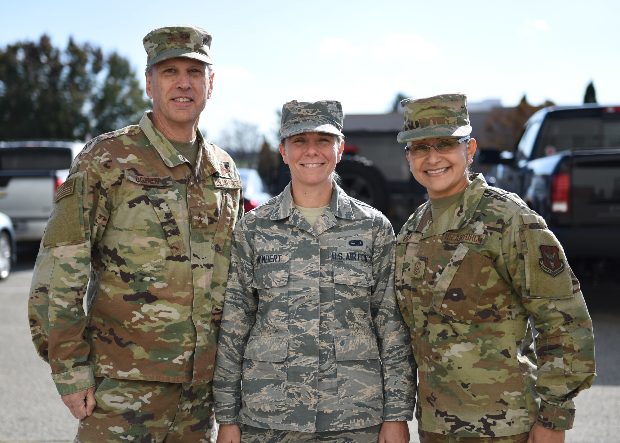 Senior Airman Brianna Humbert, 911th Maintenance Squadron crew chief, poses for a photo with Maj. Gen. Randall A. Ogden, 4th Air Force commander and Chief Master Sgt. Cynthia Villa, 4th AF command chief, after receiving a challenge coin at the Pittsburgh International Airport Air Reserve Station, Pennsylvania, Nov. 3, 2019.