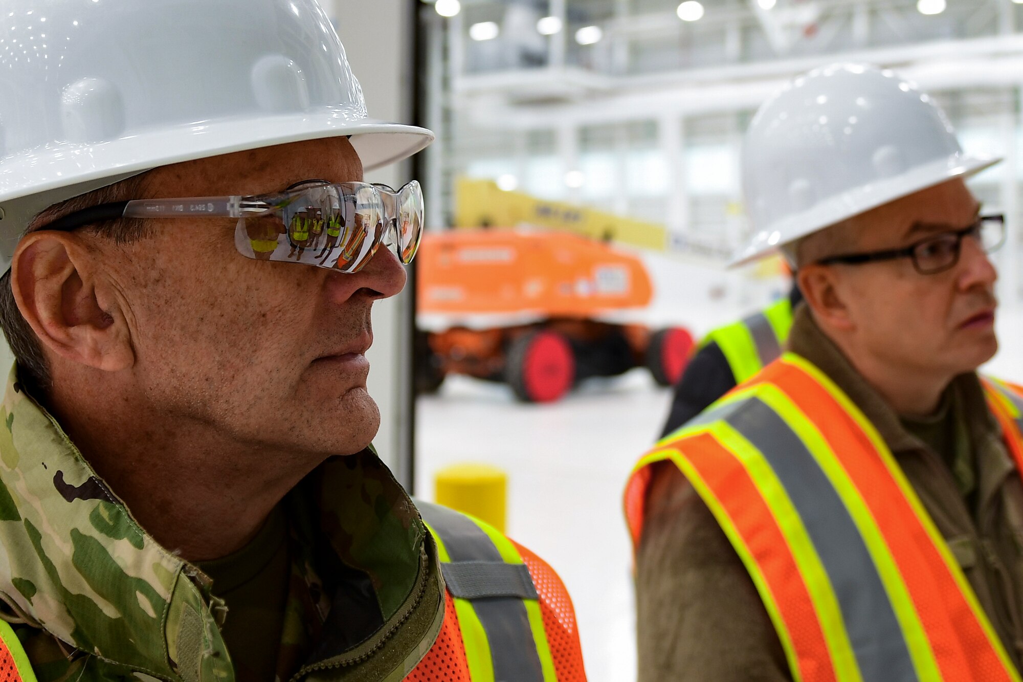 Maj. Gen. Randall A. Ogden, 4th Air Force commander, and Chief Master Sgt. Christopher D. Neitzel, 911th Airlift Wing command chief, listen to contractors talk about the new two-bay hangar at the Pittsburgh International Airport Air Reserve Station, Pennsylvania, Nov 4, 2019.